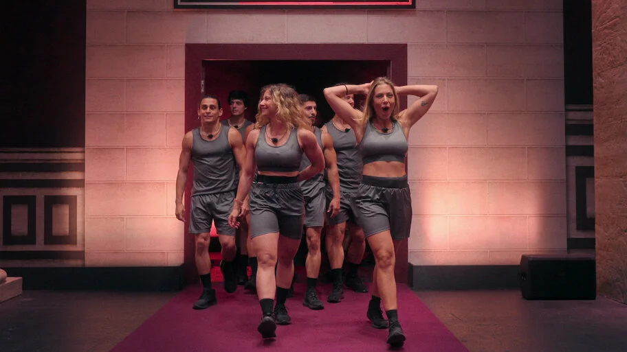 A group of Physical 100: Italy contestants enters the arena in an official Netflix still.