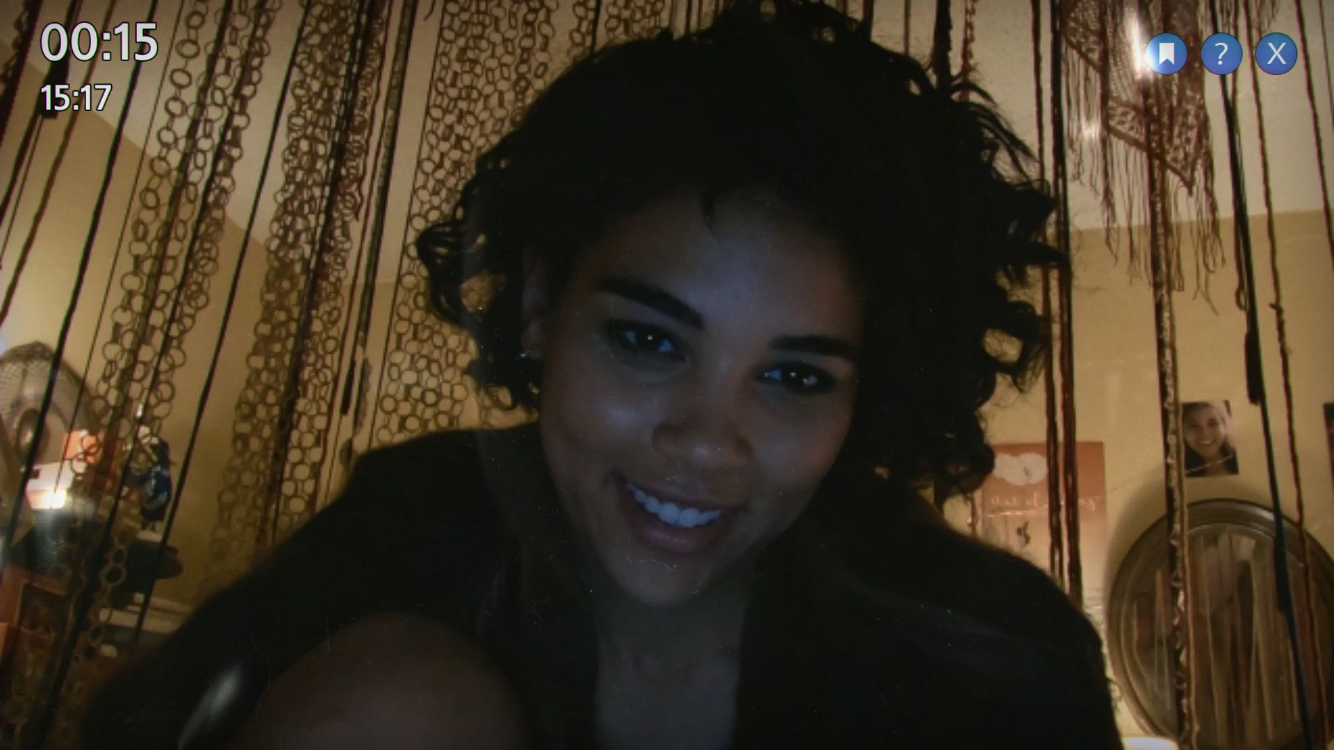 A woman appears in a recording with time and window controls visible, showing the game’s video-led presentation.