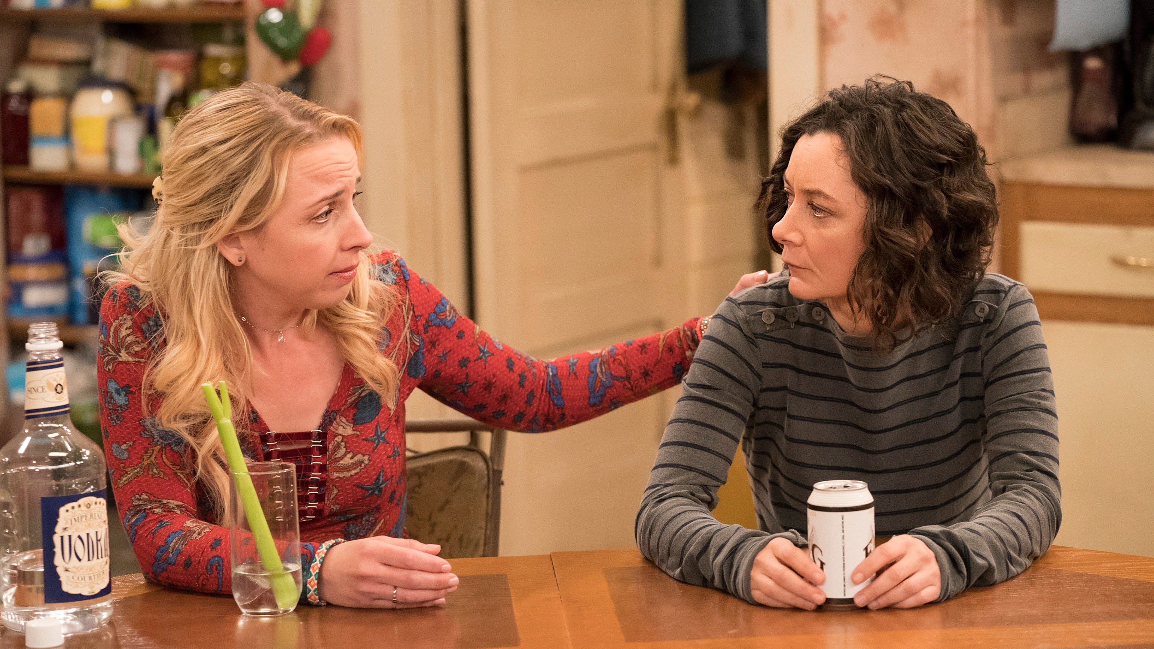 Darlene and Becky talk at the kitchen table.
