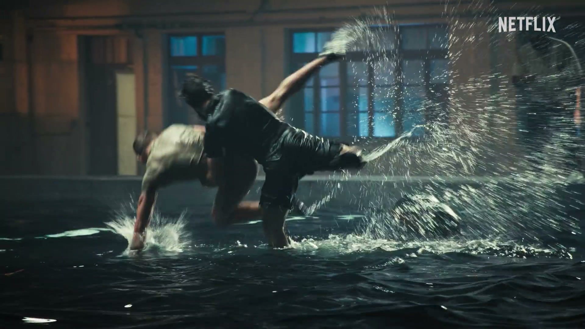 A competitor works through a water-based physical challenge in the official trailer.