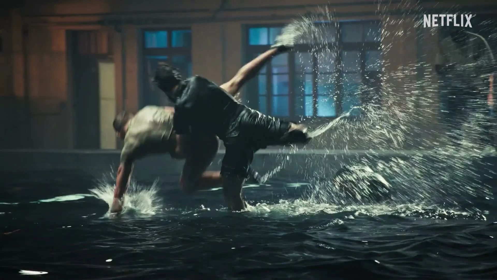 A competitor works through a water-based physical challenge in the official trailer.