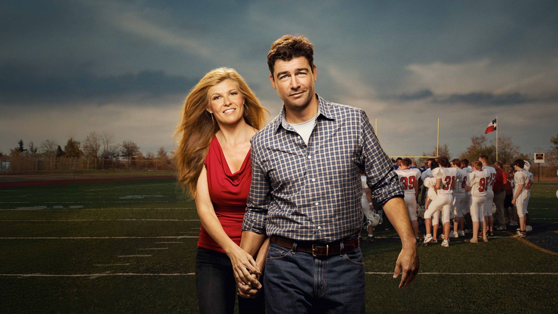 Kyle Chandler and Connie Britton as Eric and Tami Taylor on a football field in Friday Night Lights.