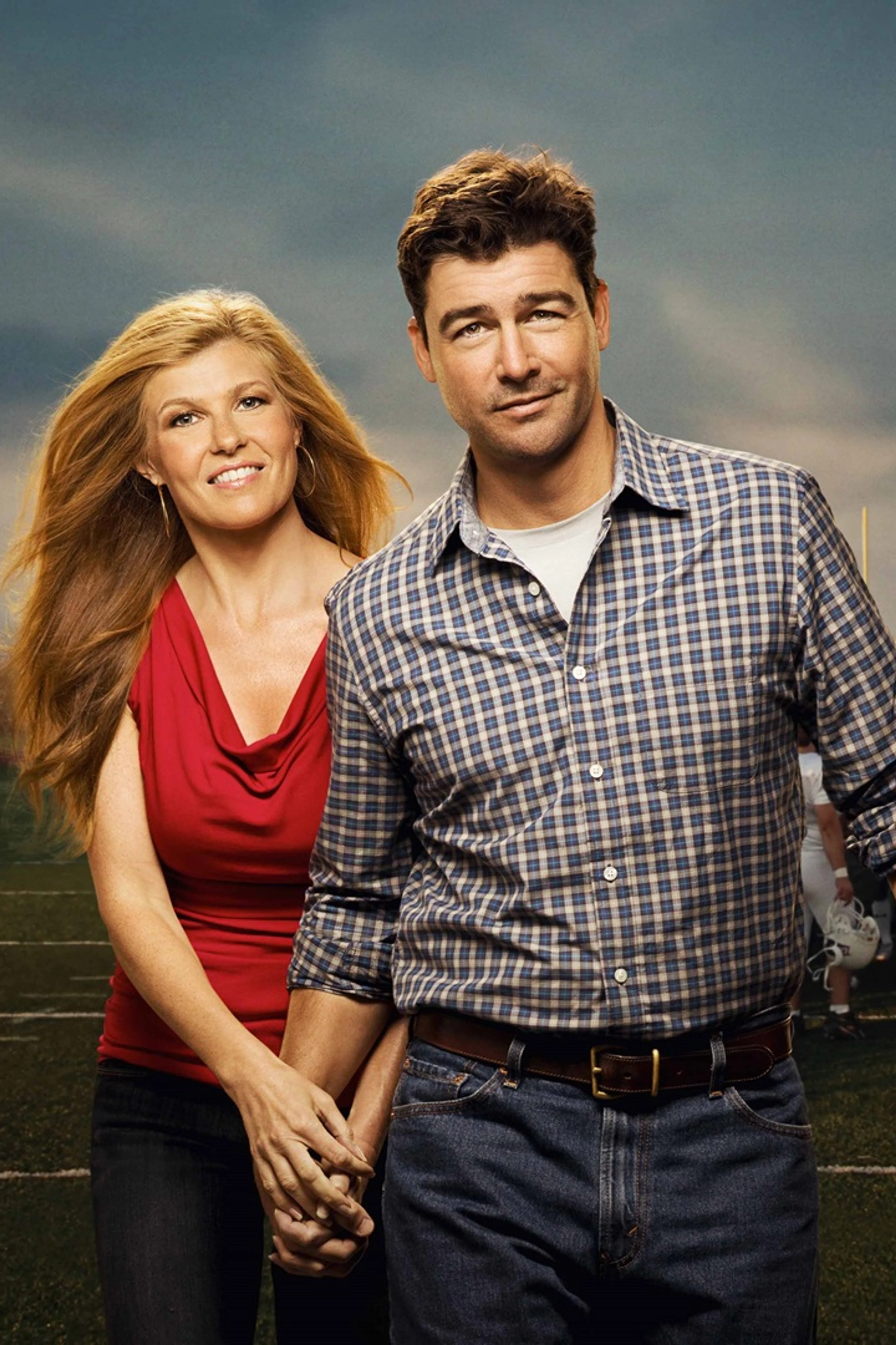 Kyle Chandler and Connie Britton as Eric and Tami Taylor on a football field in Friday Night Lights.
