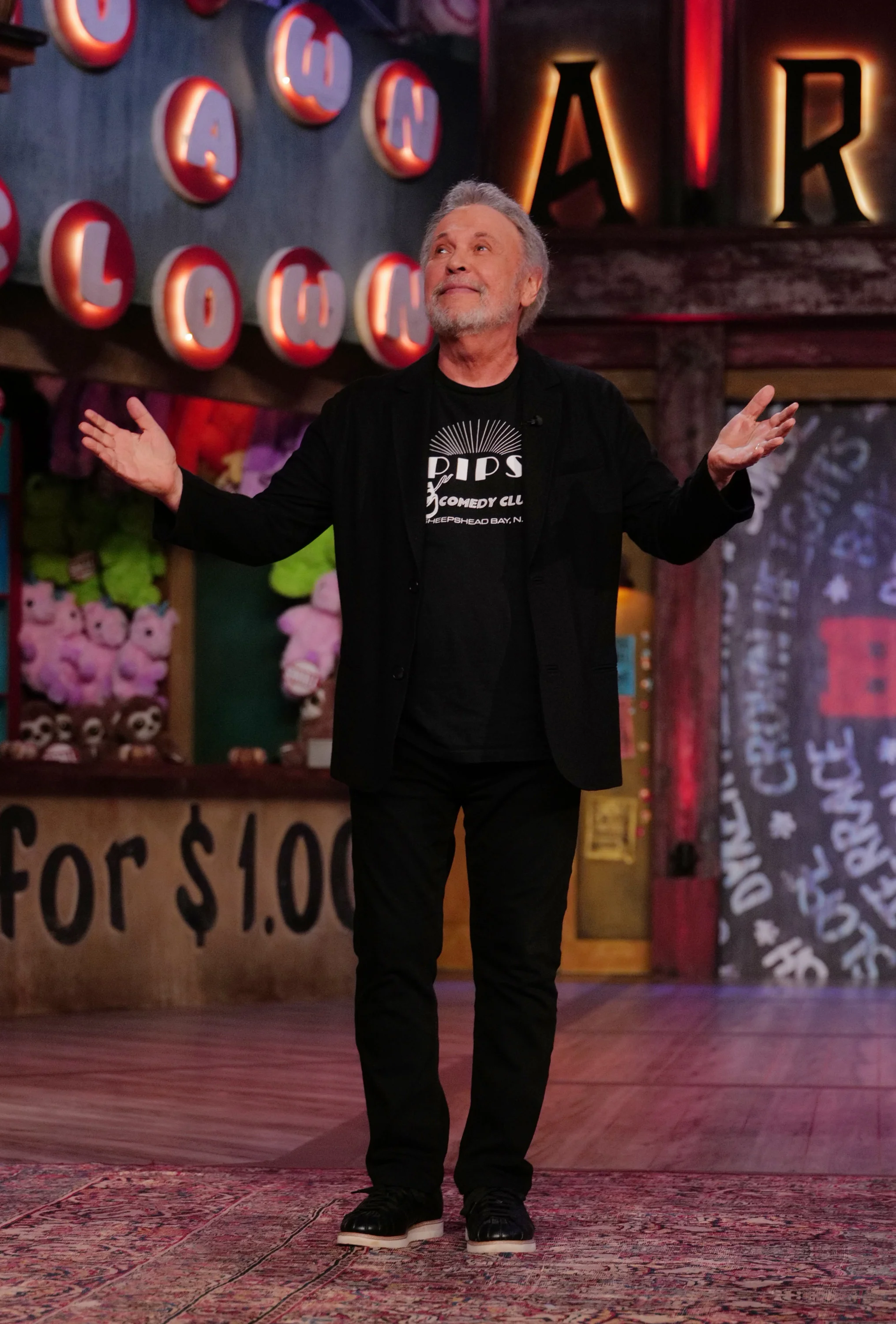 Billy Crystal stands on the Jimmy Kimmel Live! stage with his arms outstretched.