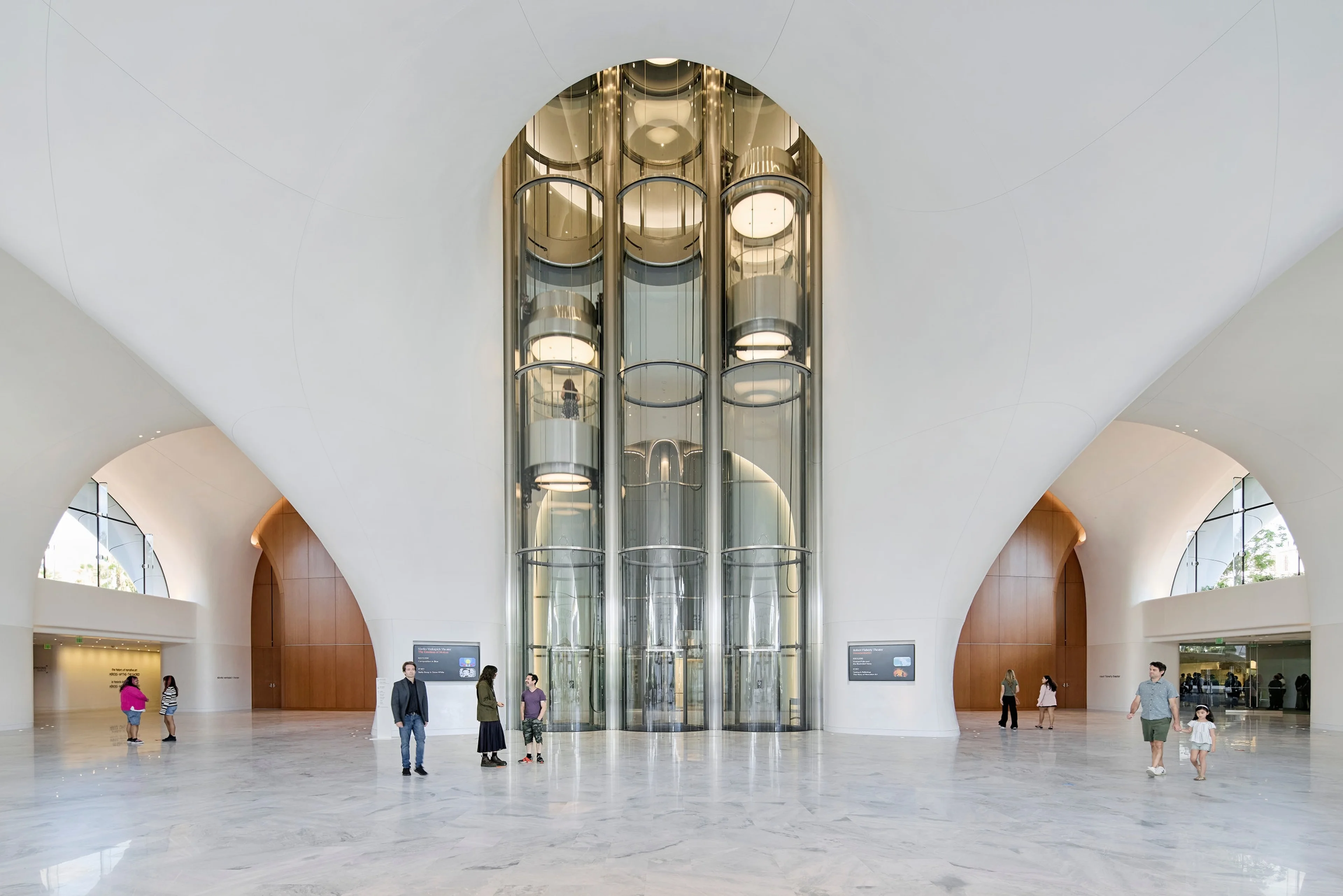 Visitors cross the bright central lobby of the Lucas Museum of Narrative Art.