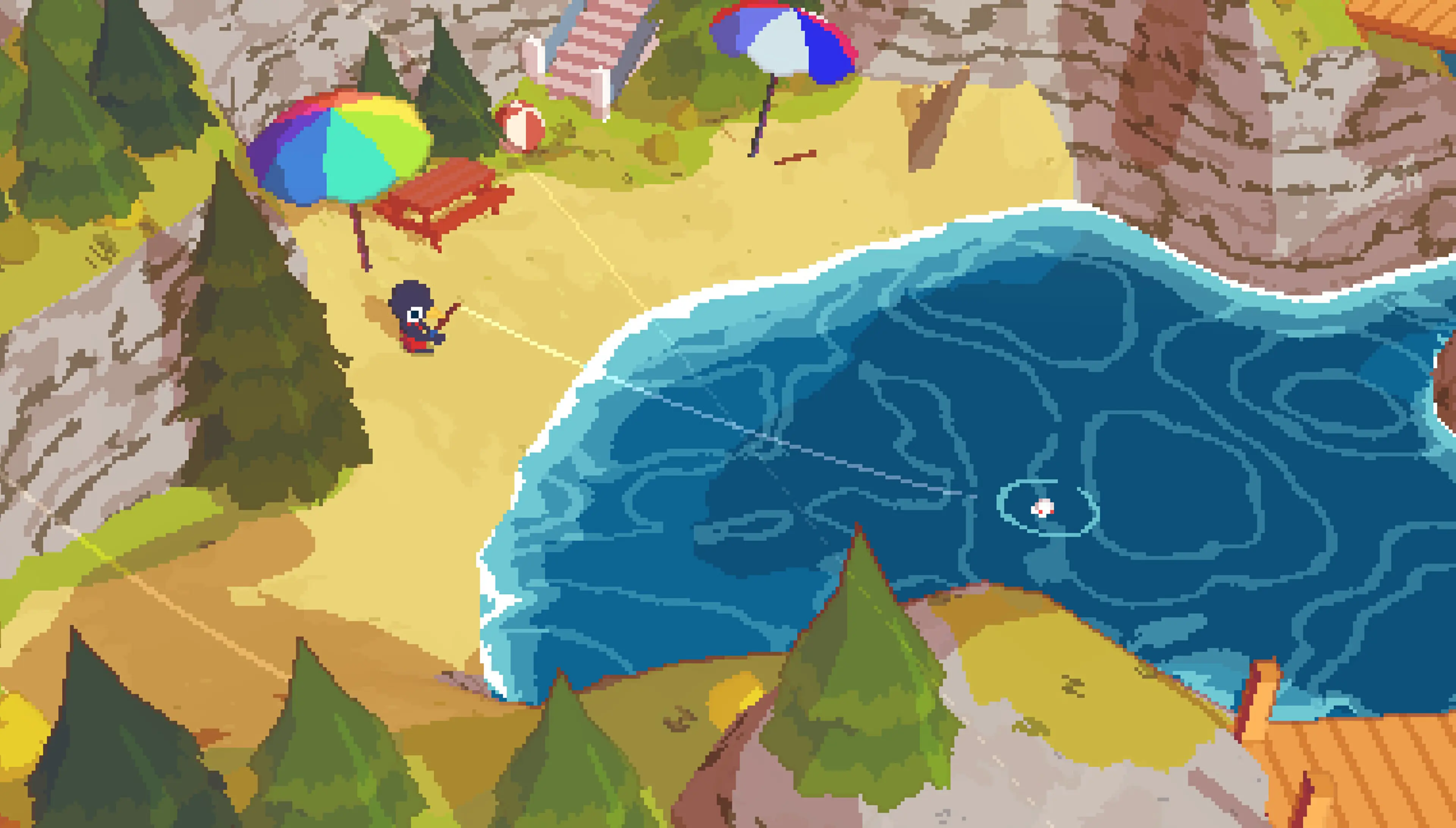 A beach with umbrellas below the cliffs of Hawk Peak.