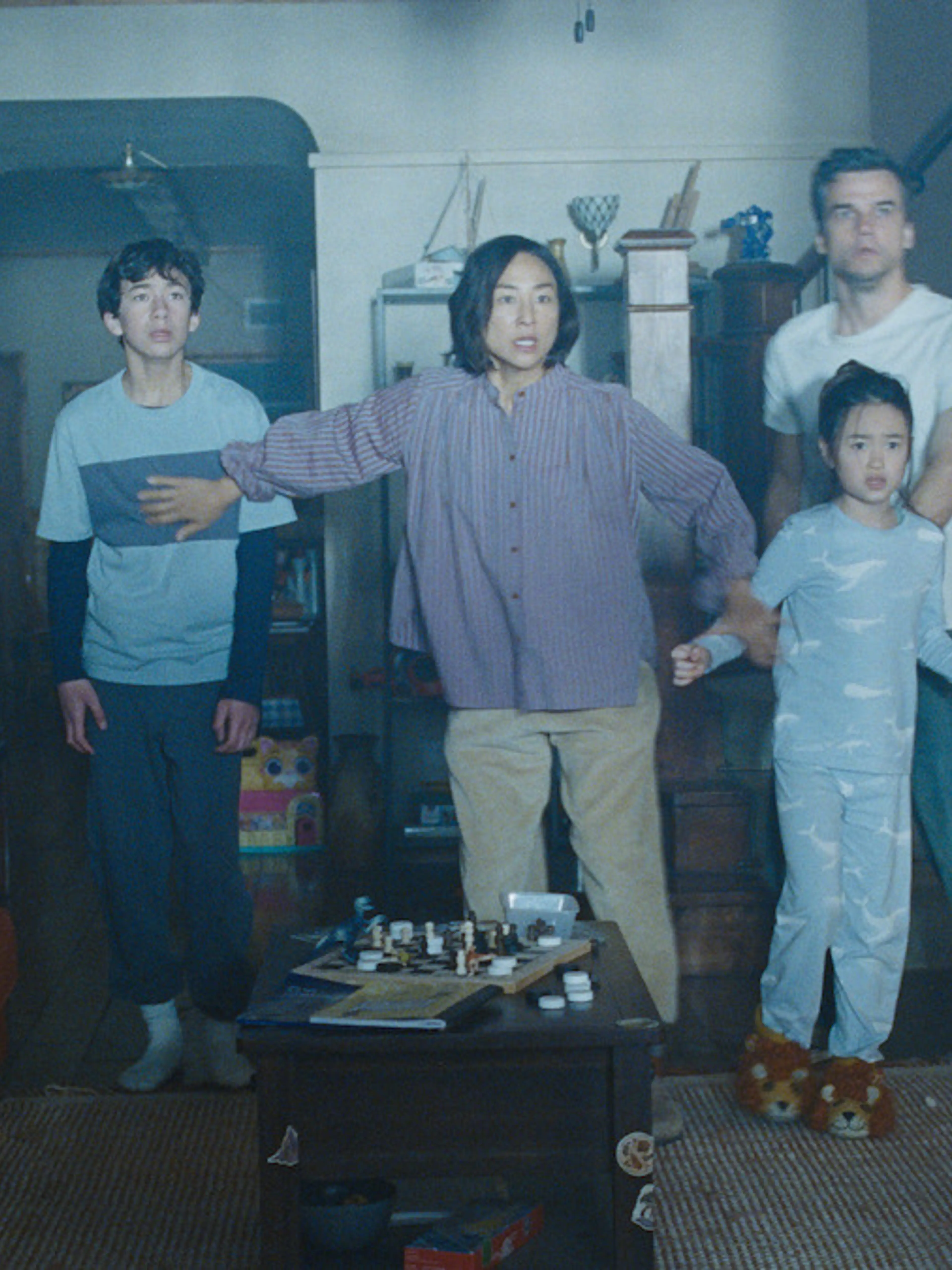 Greta Lee, Wagner Moura, and their children inside the sealed house in The Last House