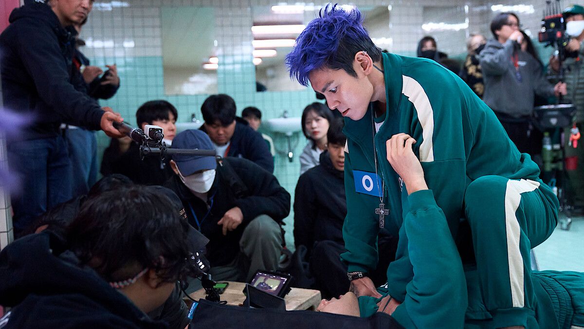 Choi Seung-hyun, known as T.O.P, with purple hair on the Squid Game Season 2 set.