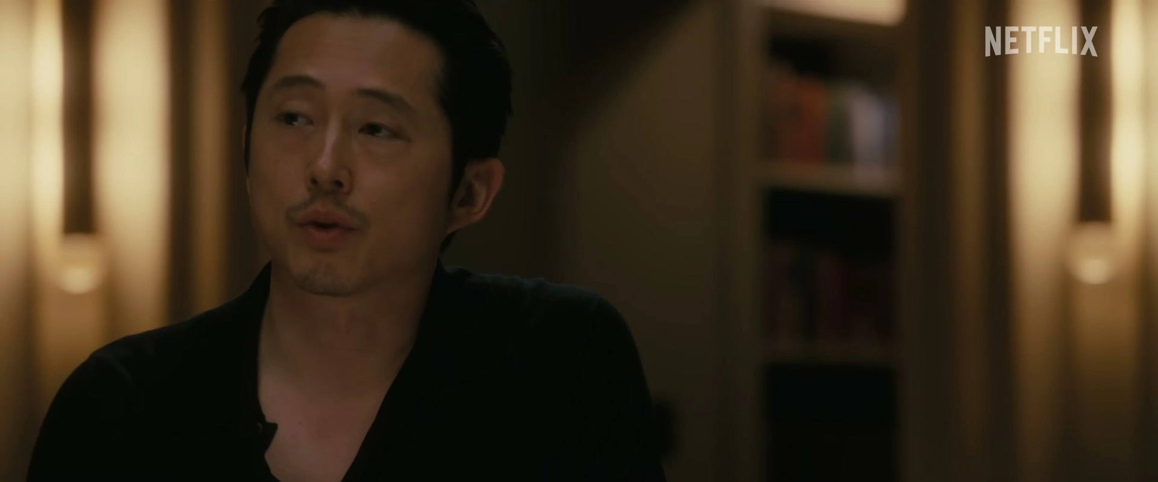 Steven Yeun looks toward someone off camera in the Animals trailer.