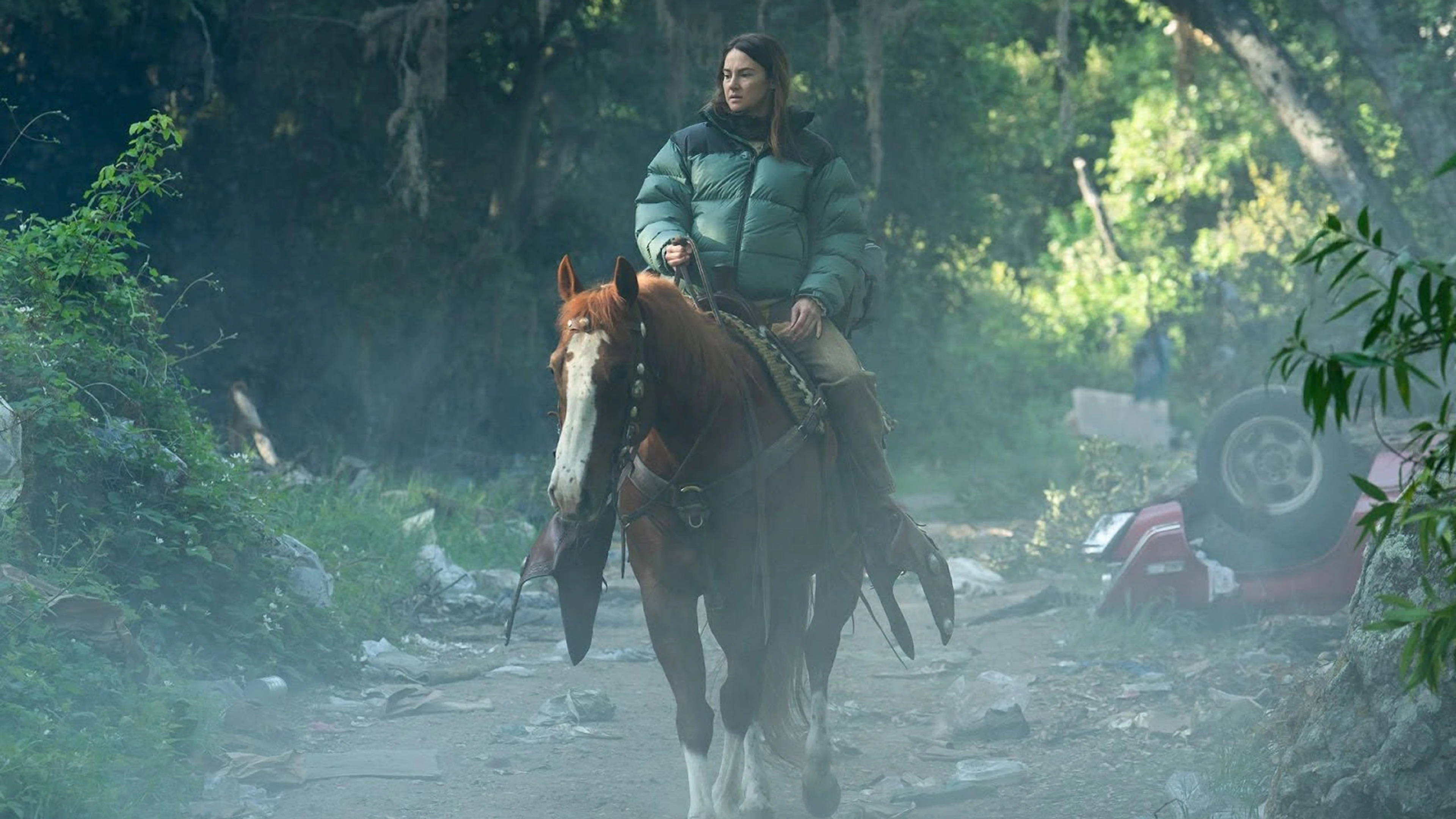 Shailene Woodley rides a horse through a wooded road as Annie in Paradise Season 2.