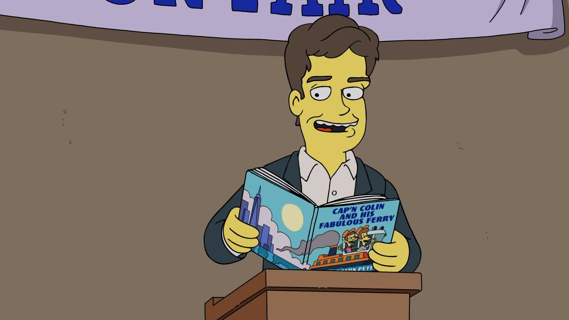 A character holds a blue children’s book.