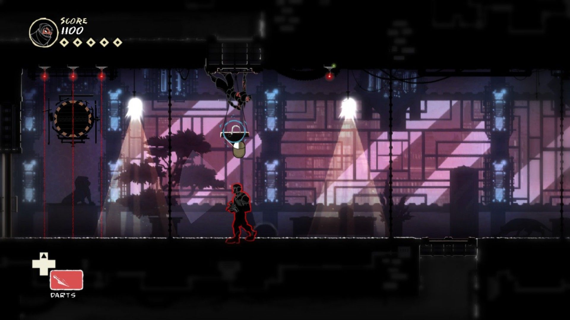 The ninja hangs above an indoor guard between lamps and laser obstacles.