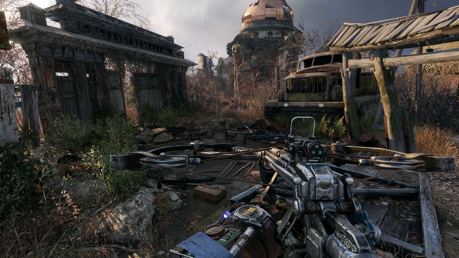 A first-person crossbow view beside a rusted bus and overgrown houses shows exploration away from the tunnels.
