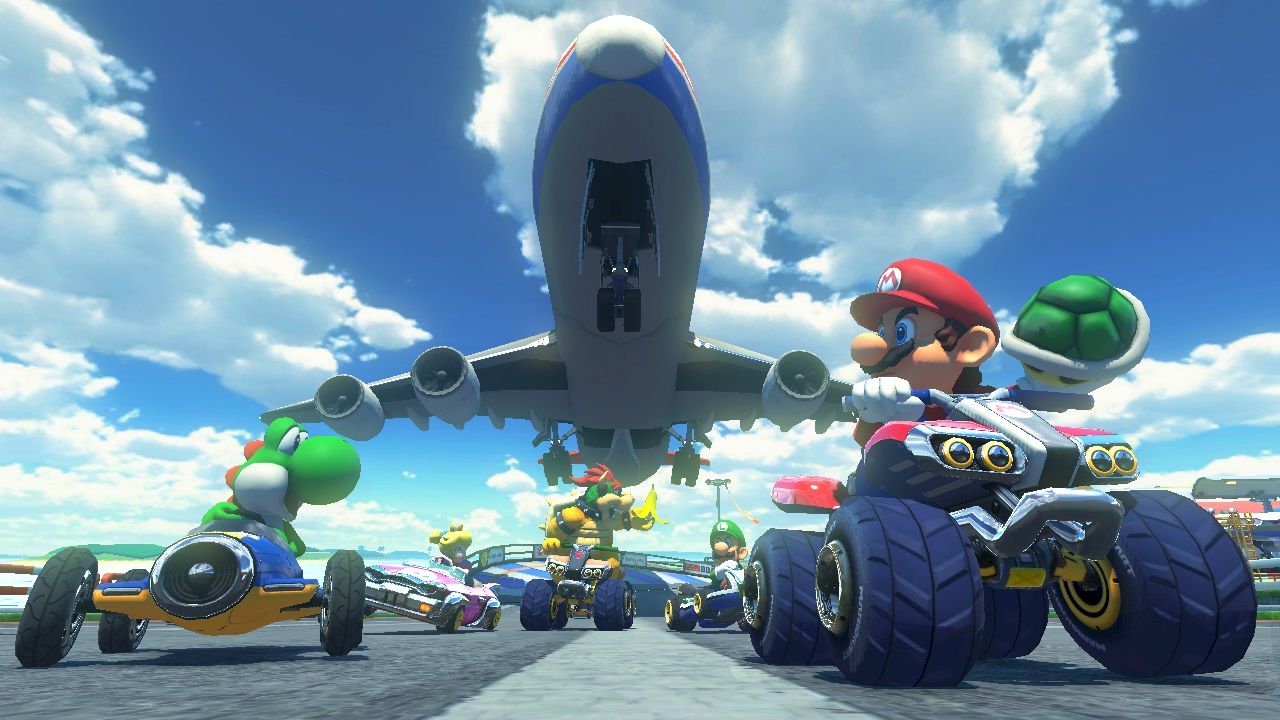 Yoshi, Mario and other racers launch from an airport runway under an airplane.