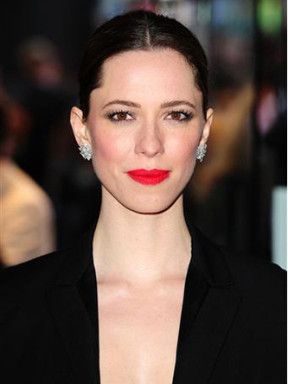 Portrait of Rebecca Hall with dark hair and a black jacket.