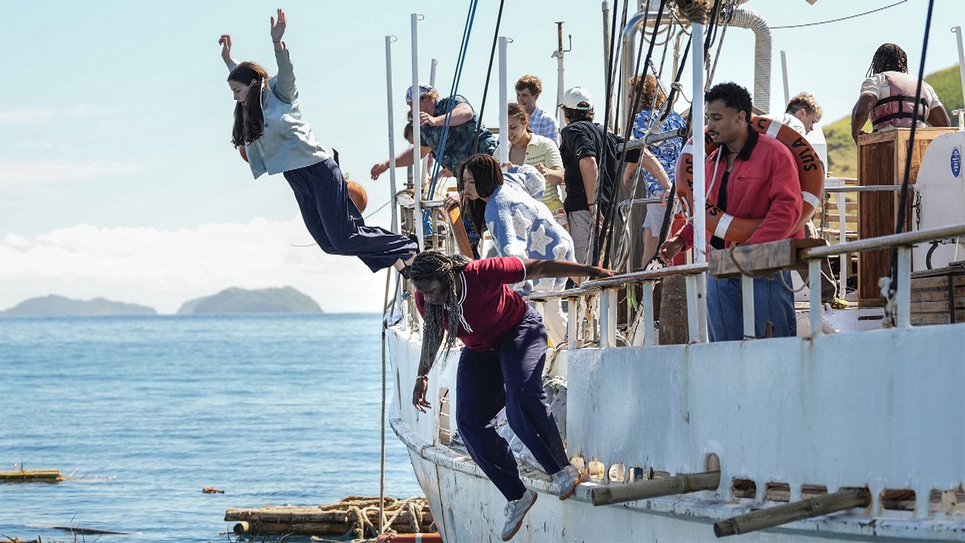 Survivor 51 contestants jump from a boat at the start of the season.