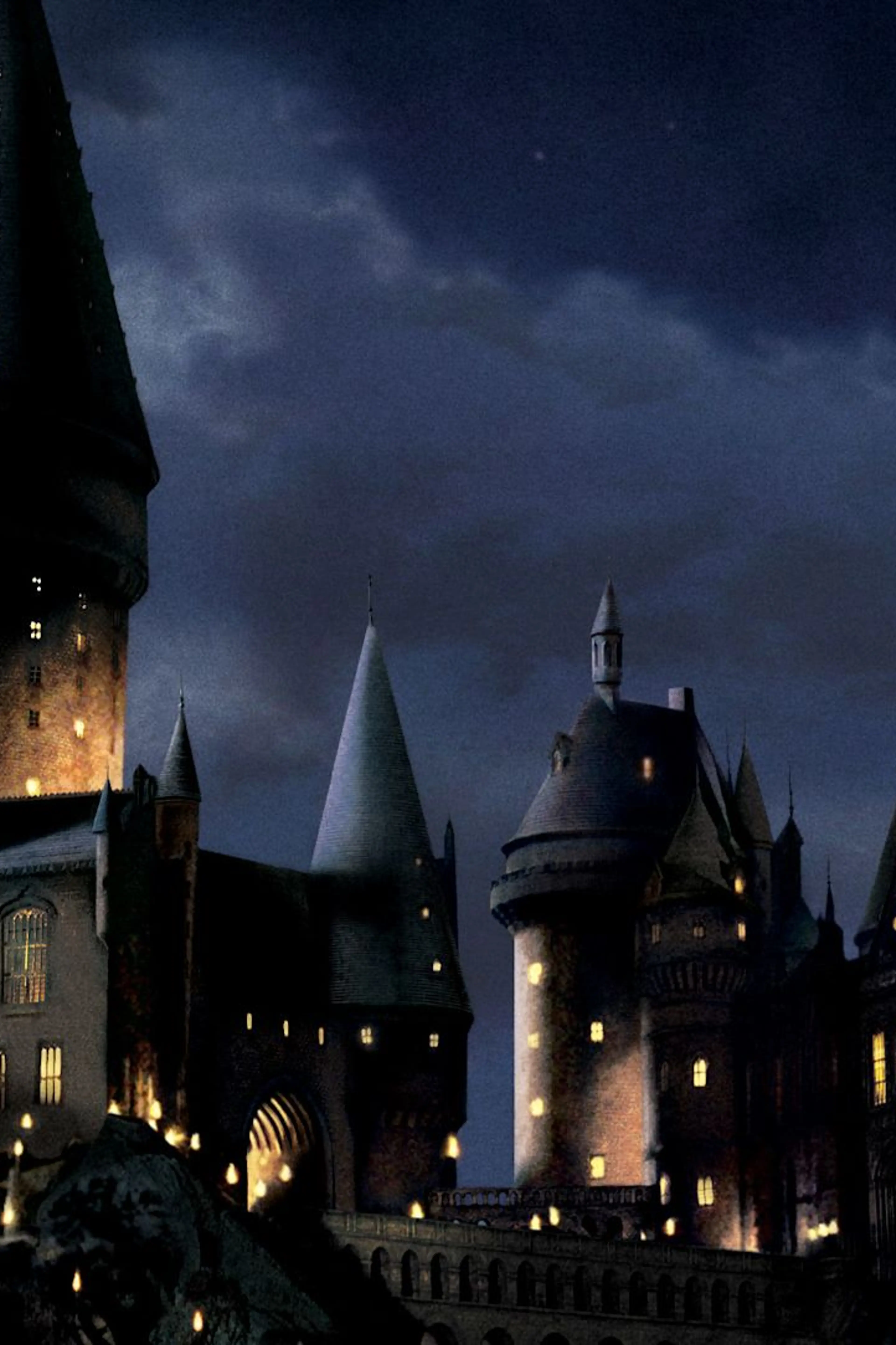 Hogwarts castle at night in official Harry Potter film artwork.
