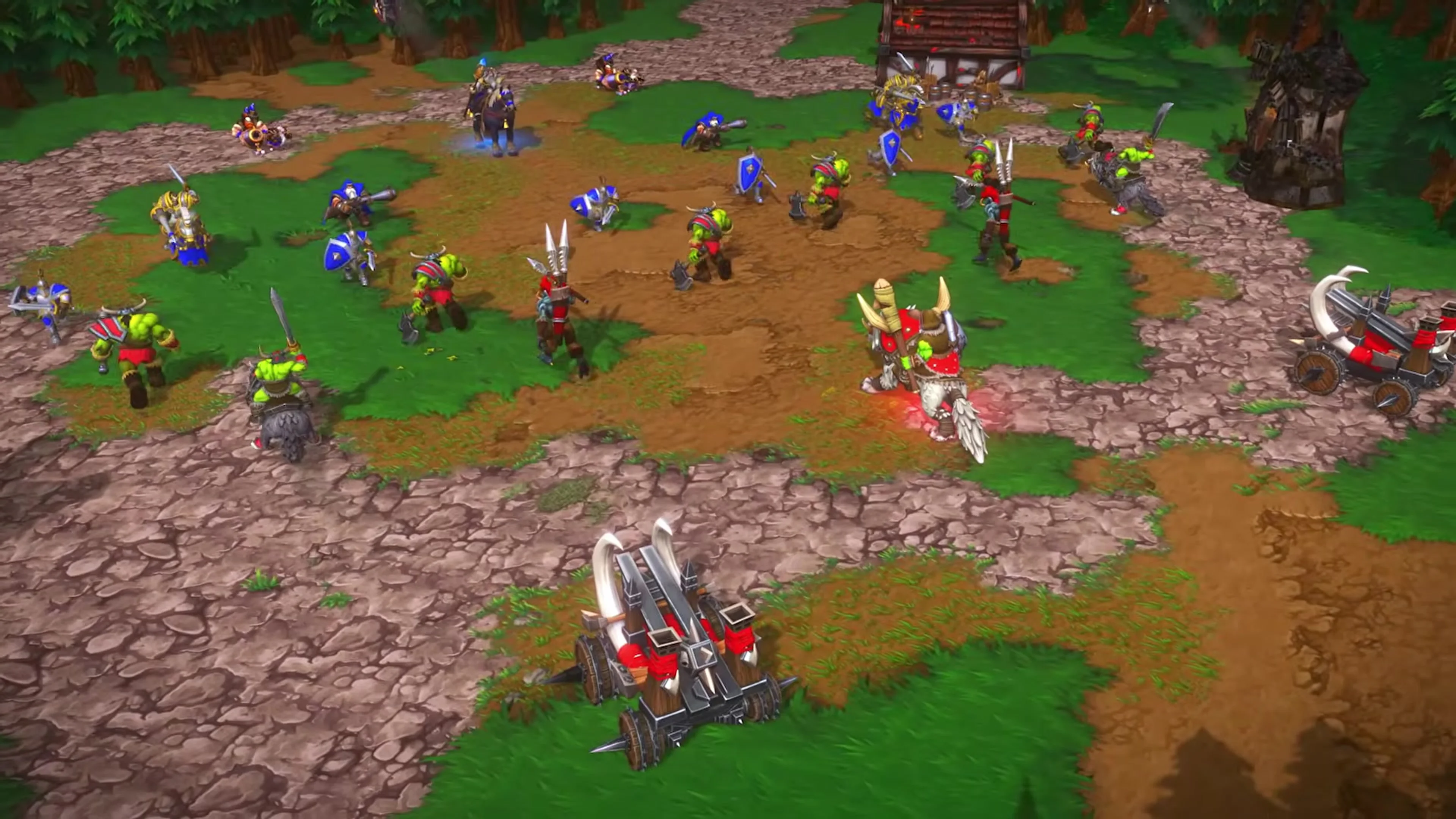Human and Orc units fight across a village road in Warcraft III: Reforged.