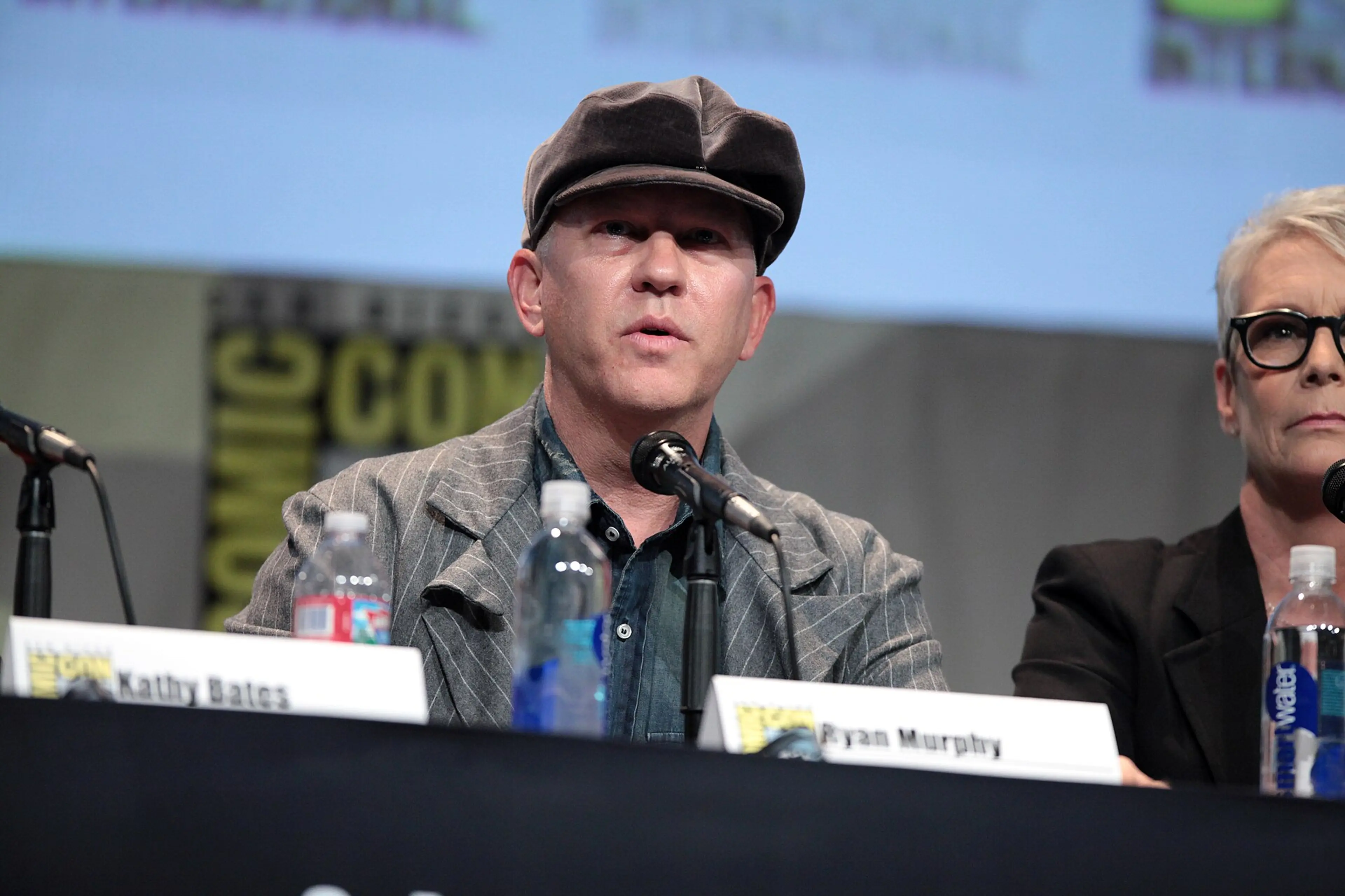 Ryan Murphy speaks into a microphone at San Diego Comic-Con in 2015.