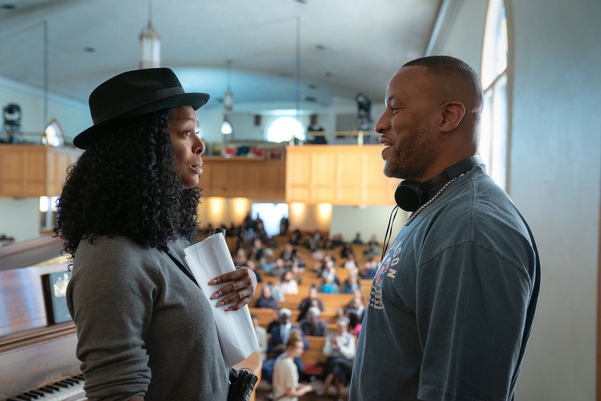 A woman and a man speak inside a church in a Give Me Some Sugah first-look photo.
