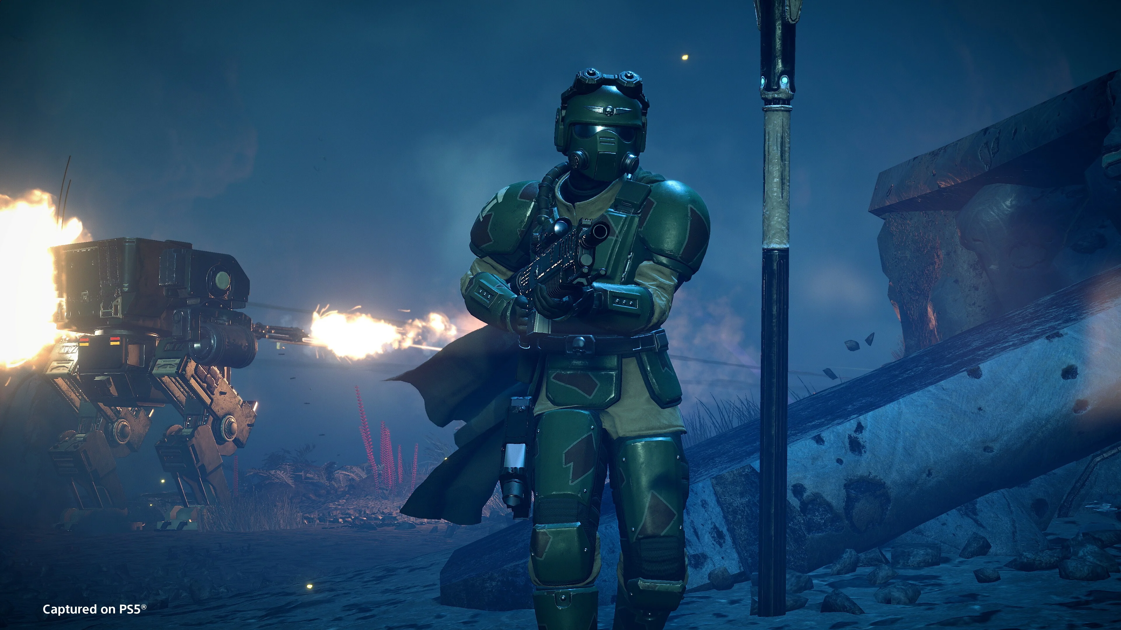 A Helldiver wears green Castellan's Creed armor while an automated turret fires behind them.