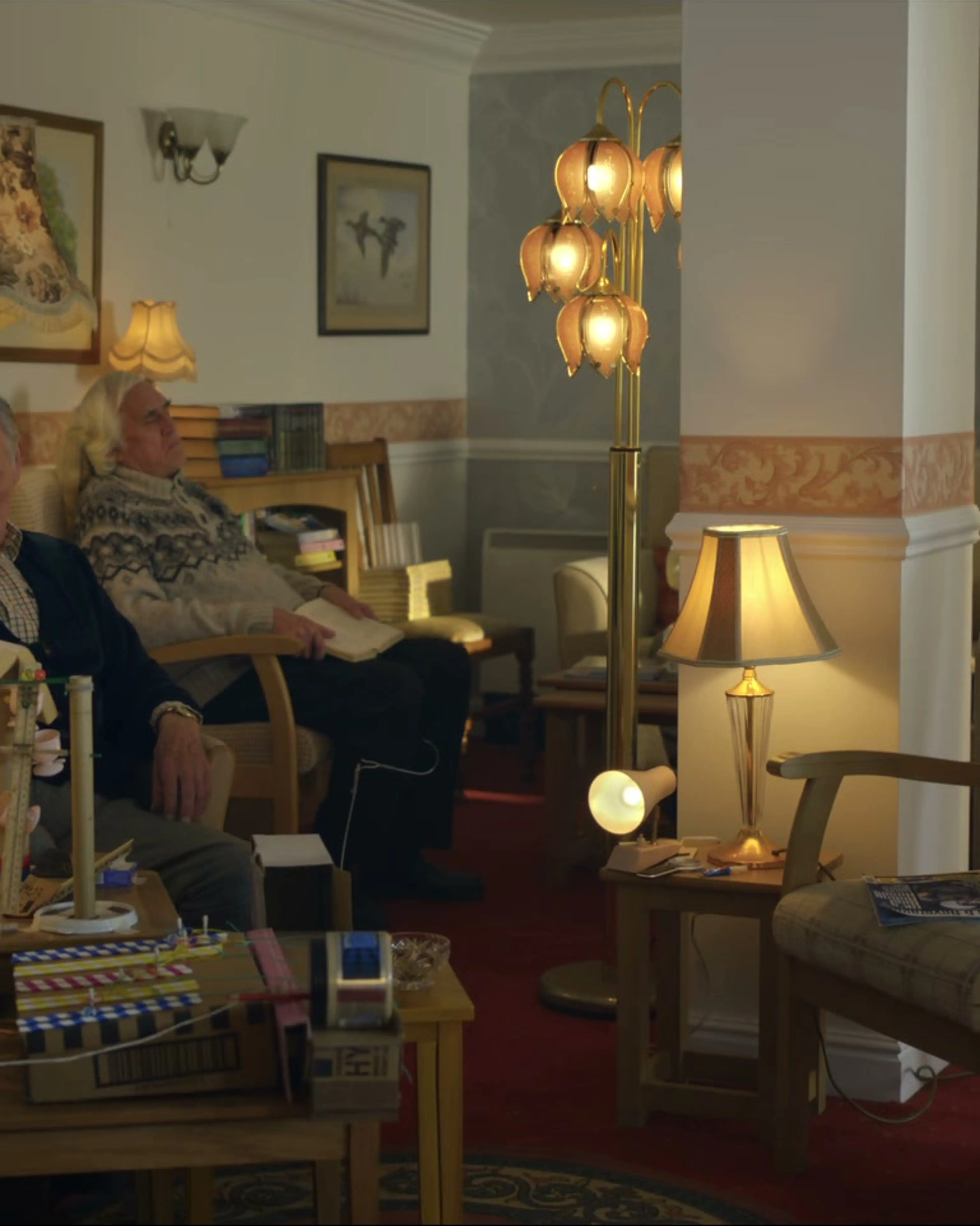 Pearce Quigley and Michael Palin sit in a living room as Michael and Brian.
