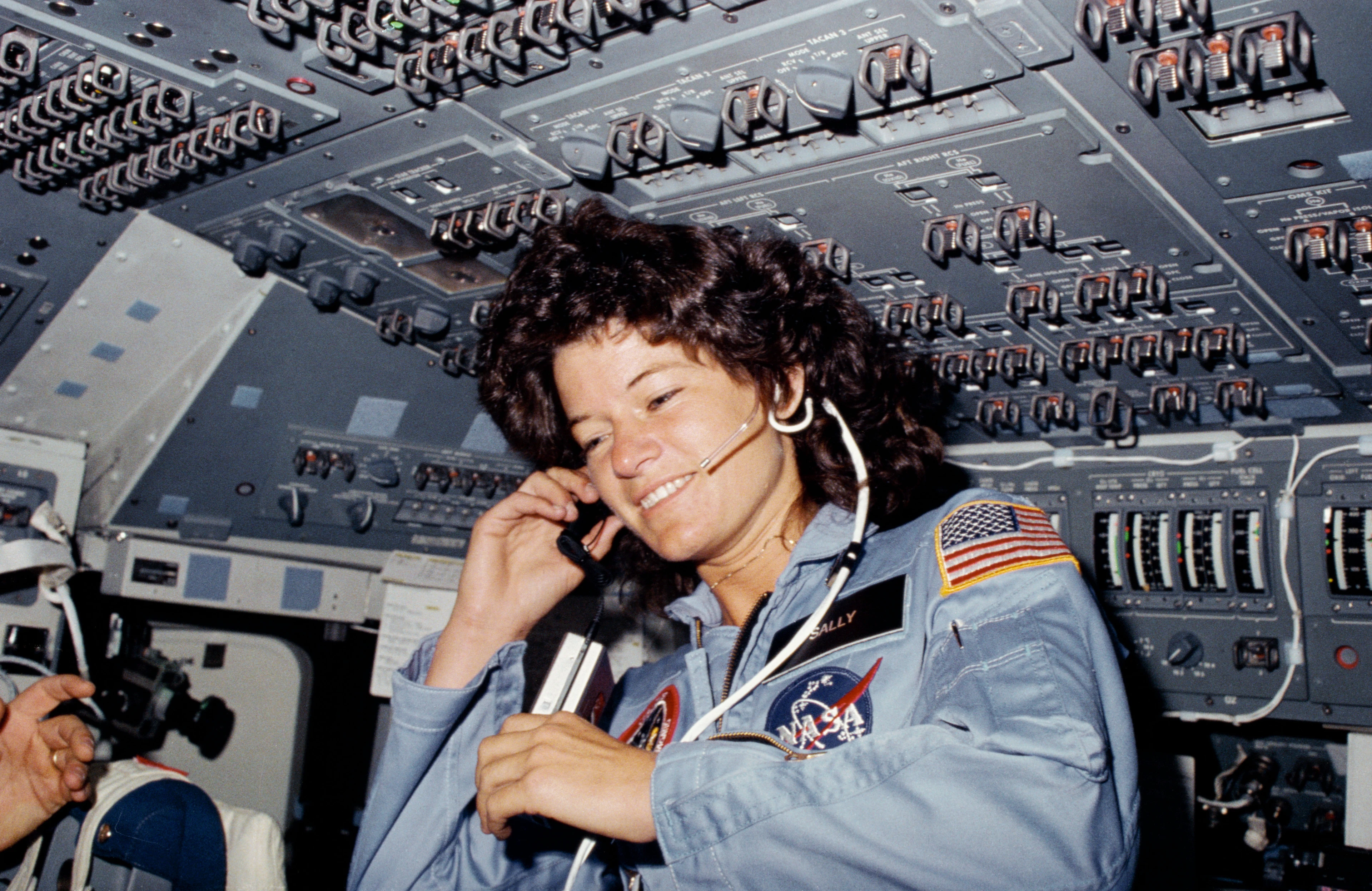 Astronaut Sally Ride works on the flight deck of the space shuttle Challenger during the 1983 STS-7 mission.