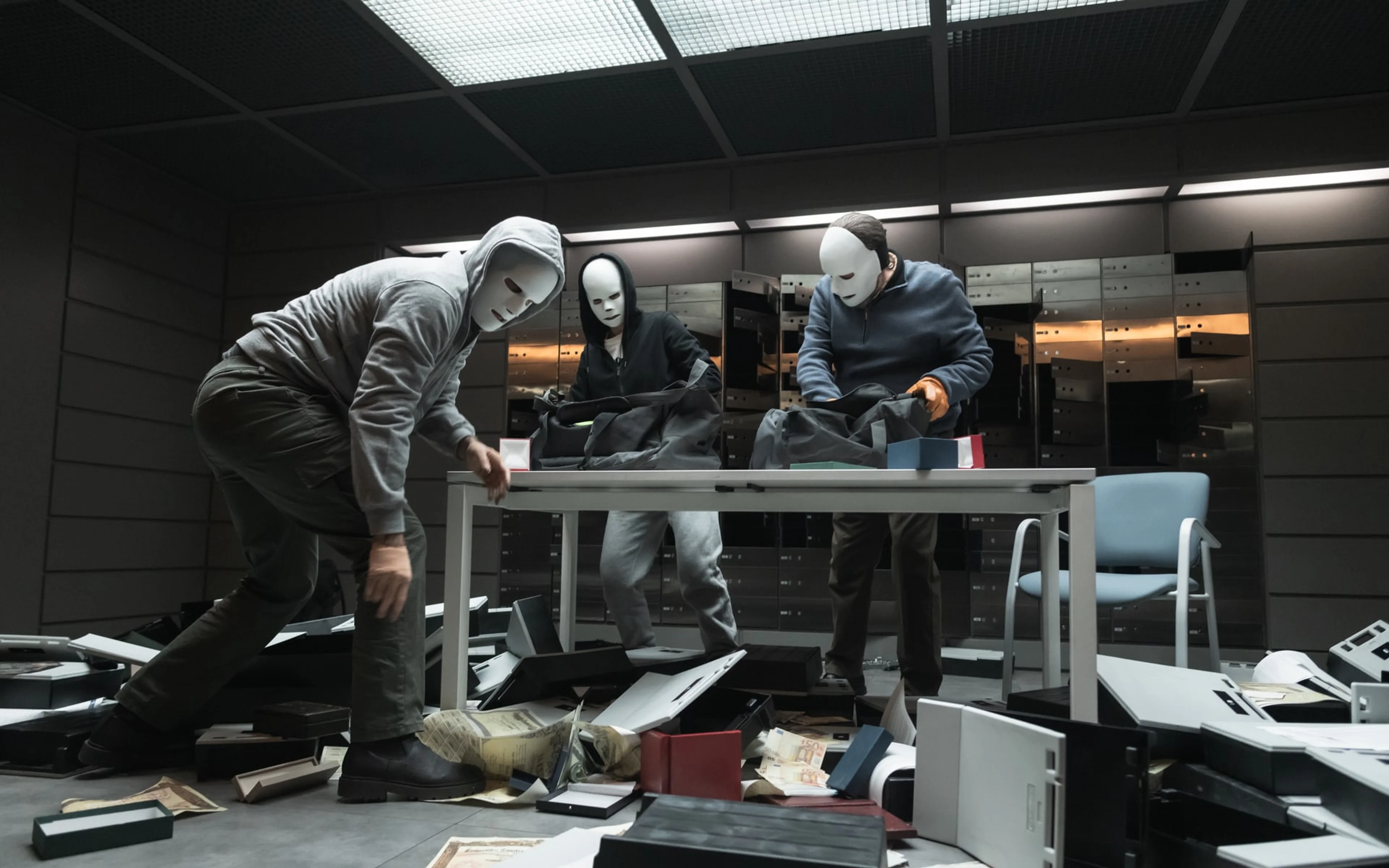 Three masked robbers search a damaged office in an official still from Collision Course.