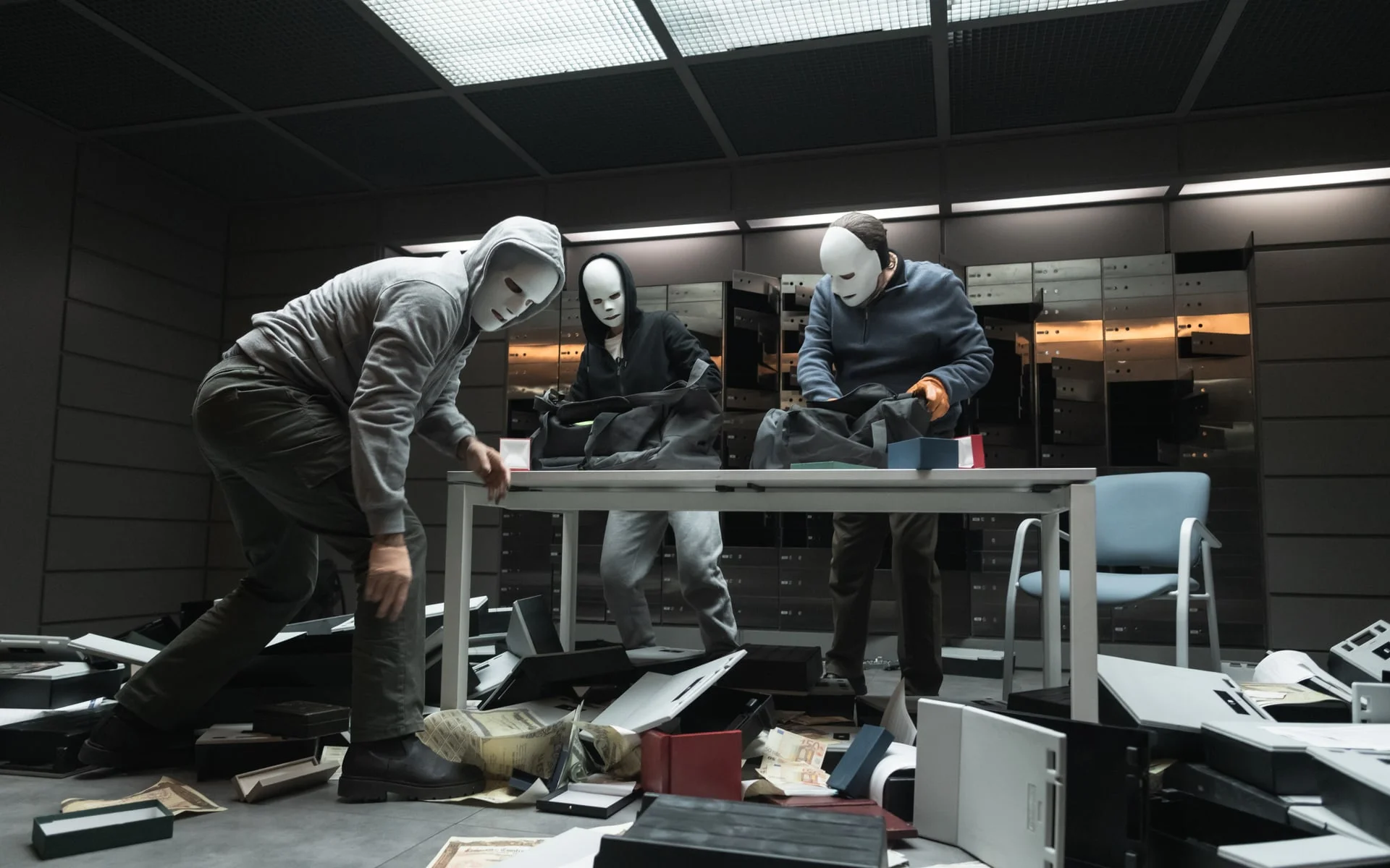 Three masked robbers search a damaged office in an official still from Collision Course.