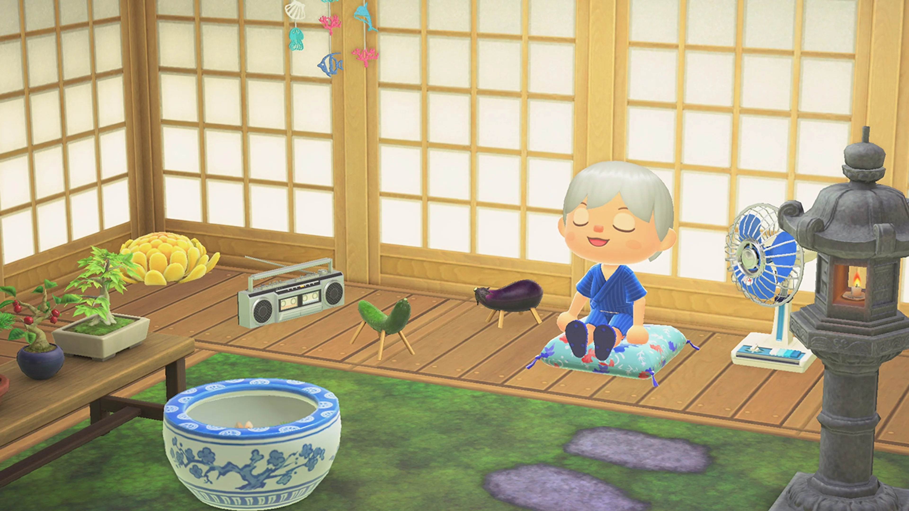 An Animal Crossing villager sits in a decorated room with a garden view.