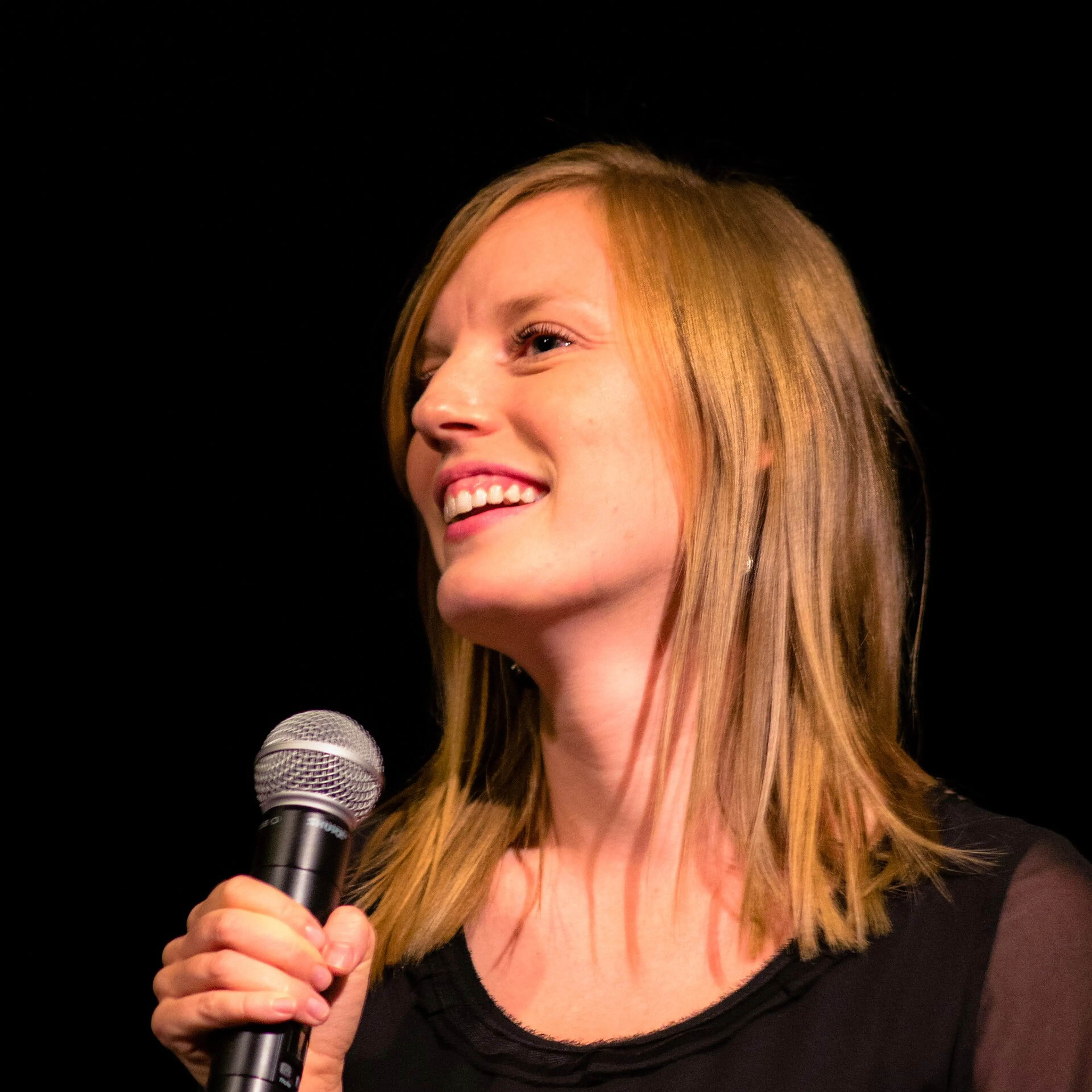 Sarah Polley speaking into a microphone at the 2012 Toronto International Film Festival.