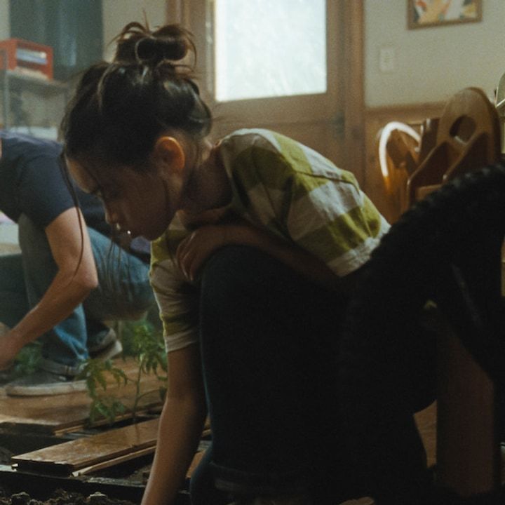 Riley Chung as Ruth tending plants inside the sealed house in The Last House.