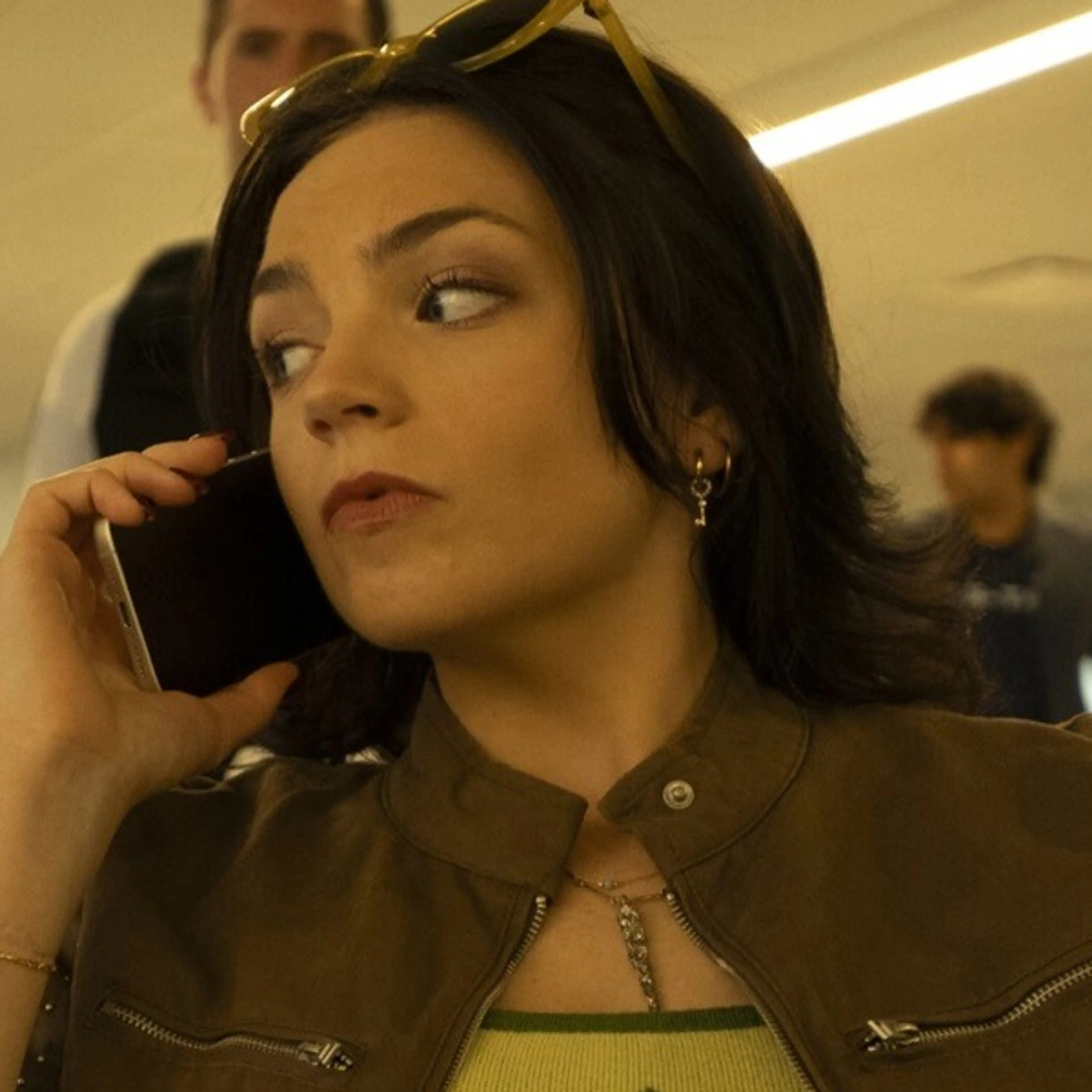 Ella Stiller as Christy Palladino, speaking on a phone in an official Cupertino production photograph.