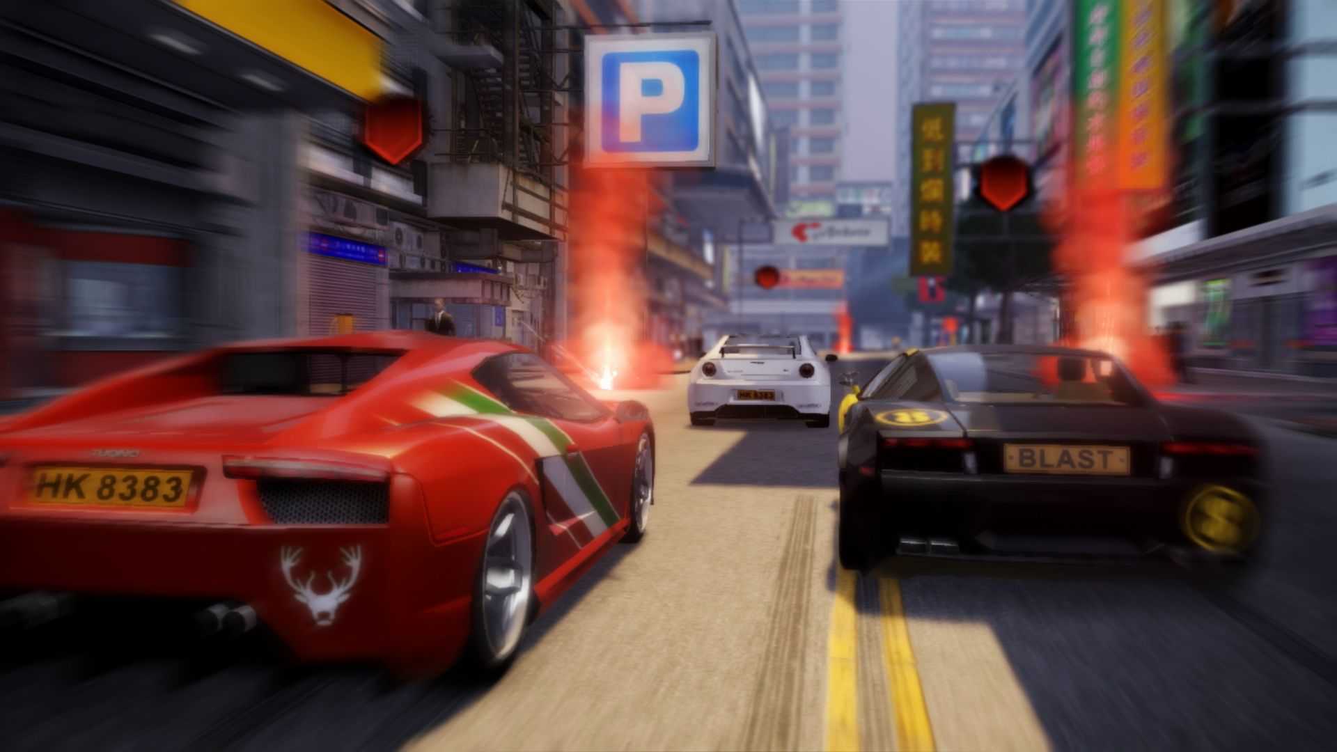 Three sports cars race past signs and smoke on a Hong Kong street.