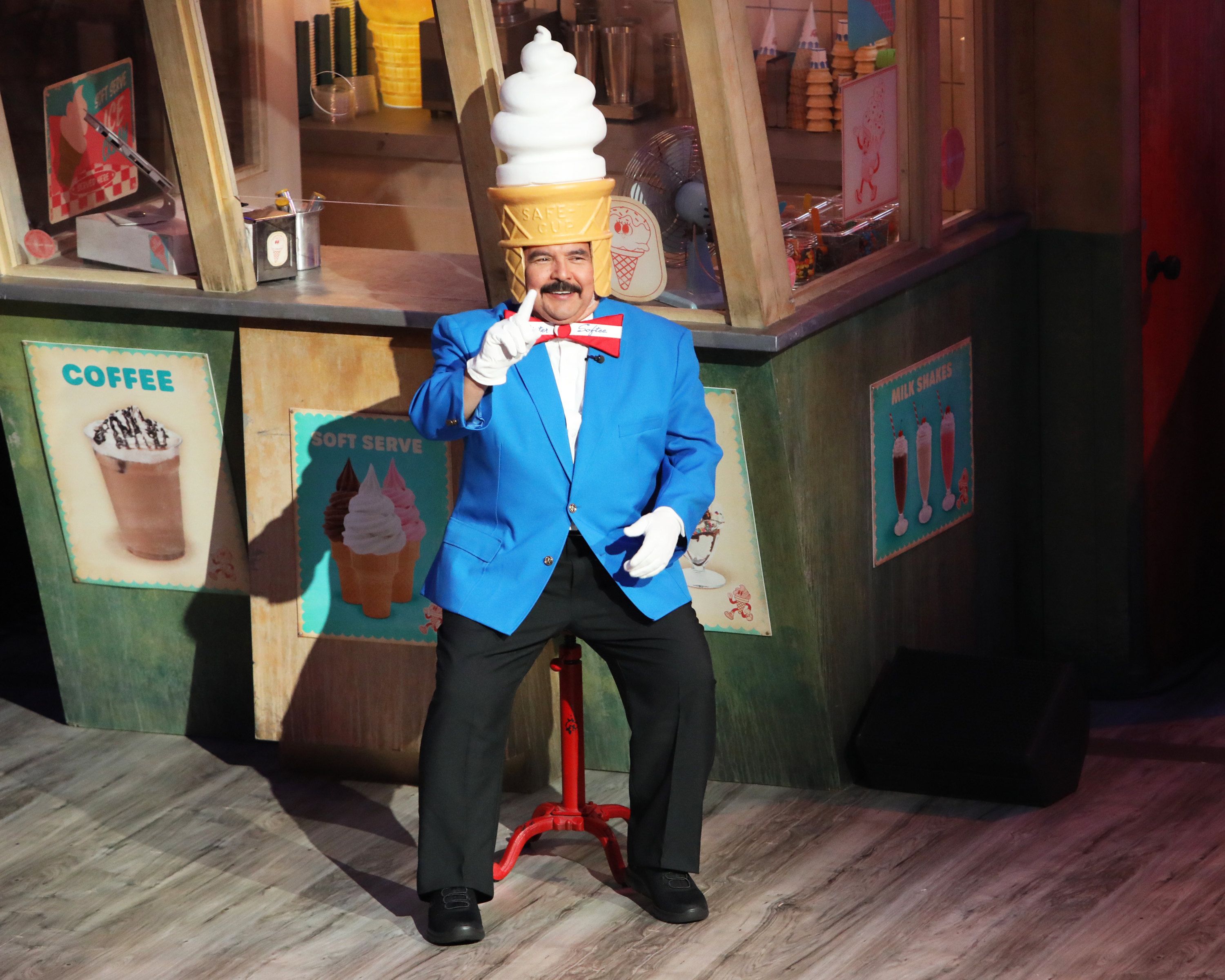 Guillermo Rodriguez wears a blue Mister Softee jacket with a large ice-cream swirl over his head.