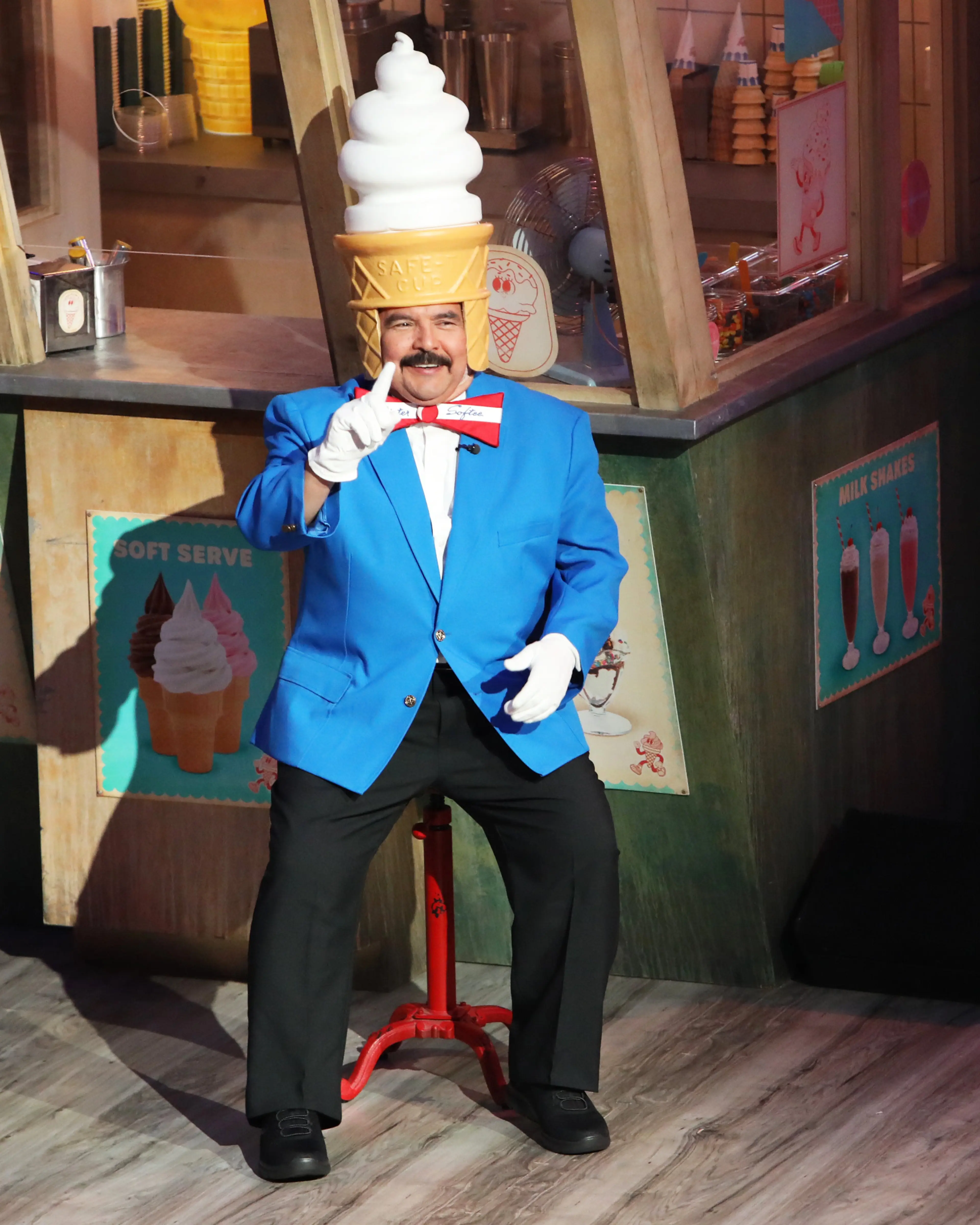 Guillermo Rodriguez wears a blue Mister Softee jacket with a large ice-cream swirl over his head.