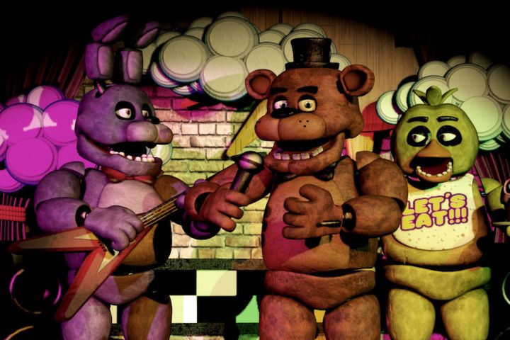 Freddy and two other animatronics stand on stage in Five Nights at Freddy's.