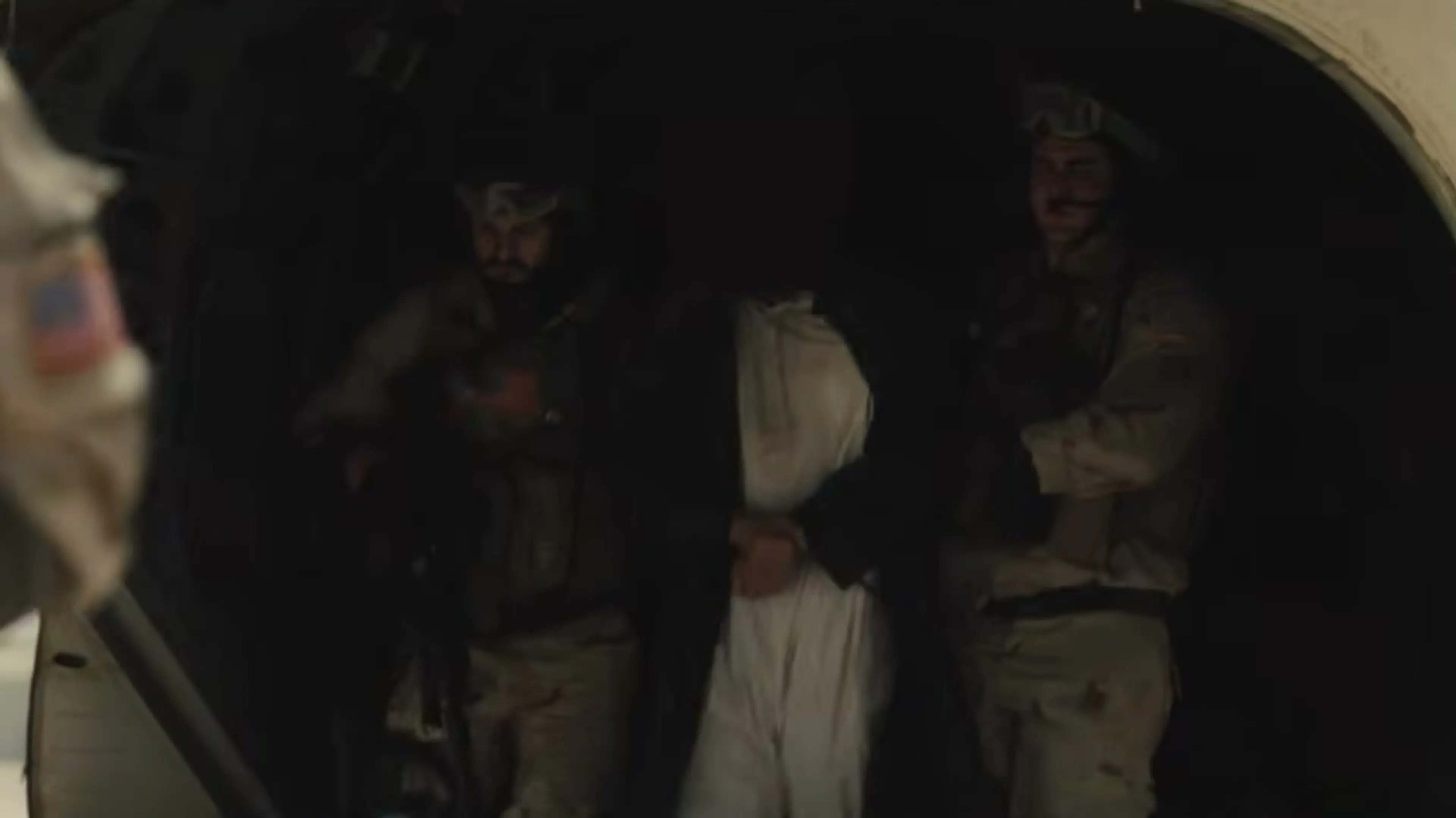 Armed soldiers search a dark doorway in a dramatized scene from High Value Target.