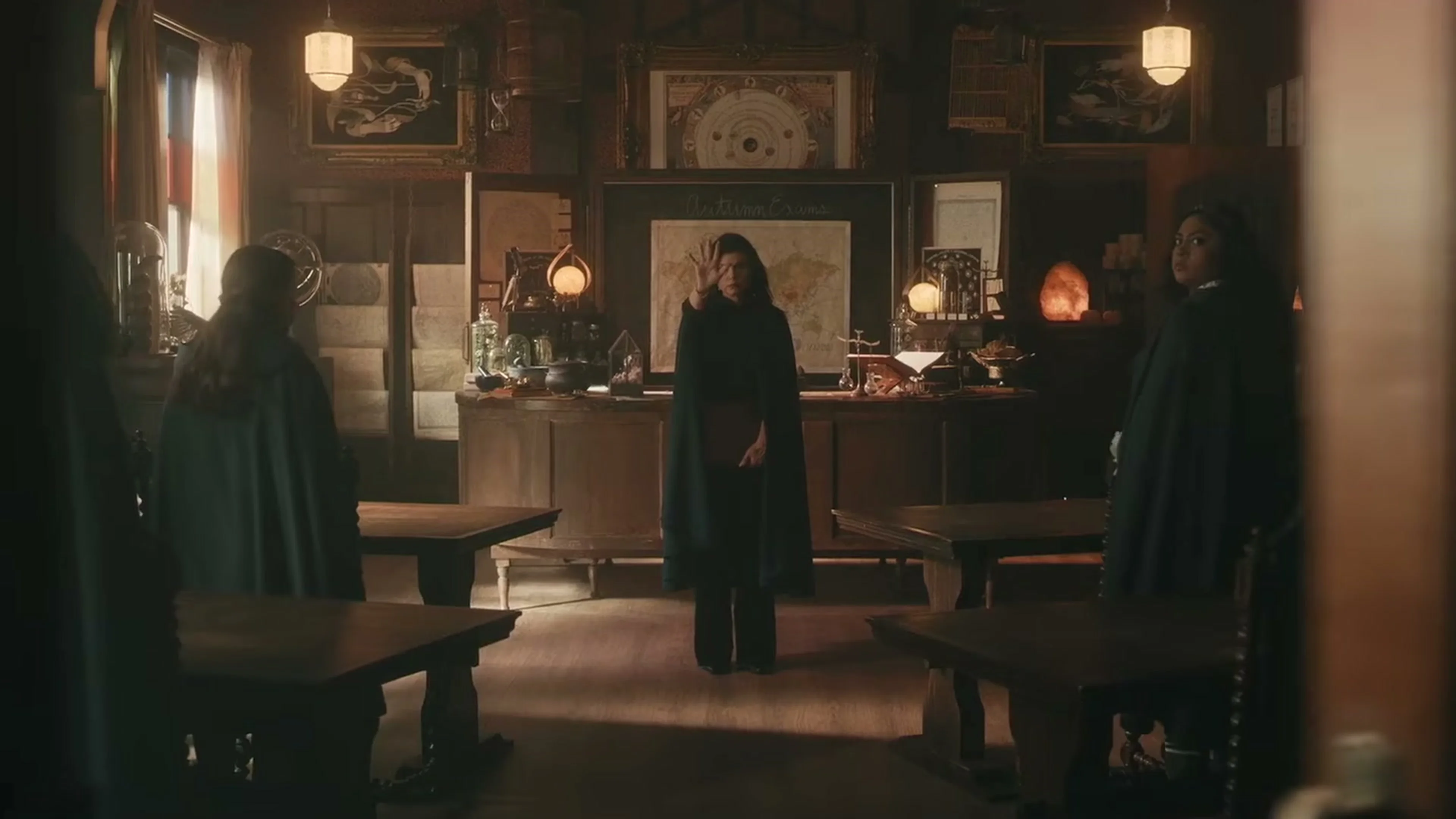 Three members of the Coven Academy faculty stand inside a formal office.