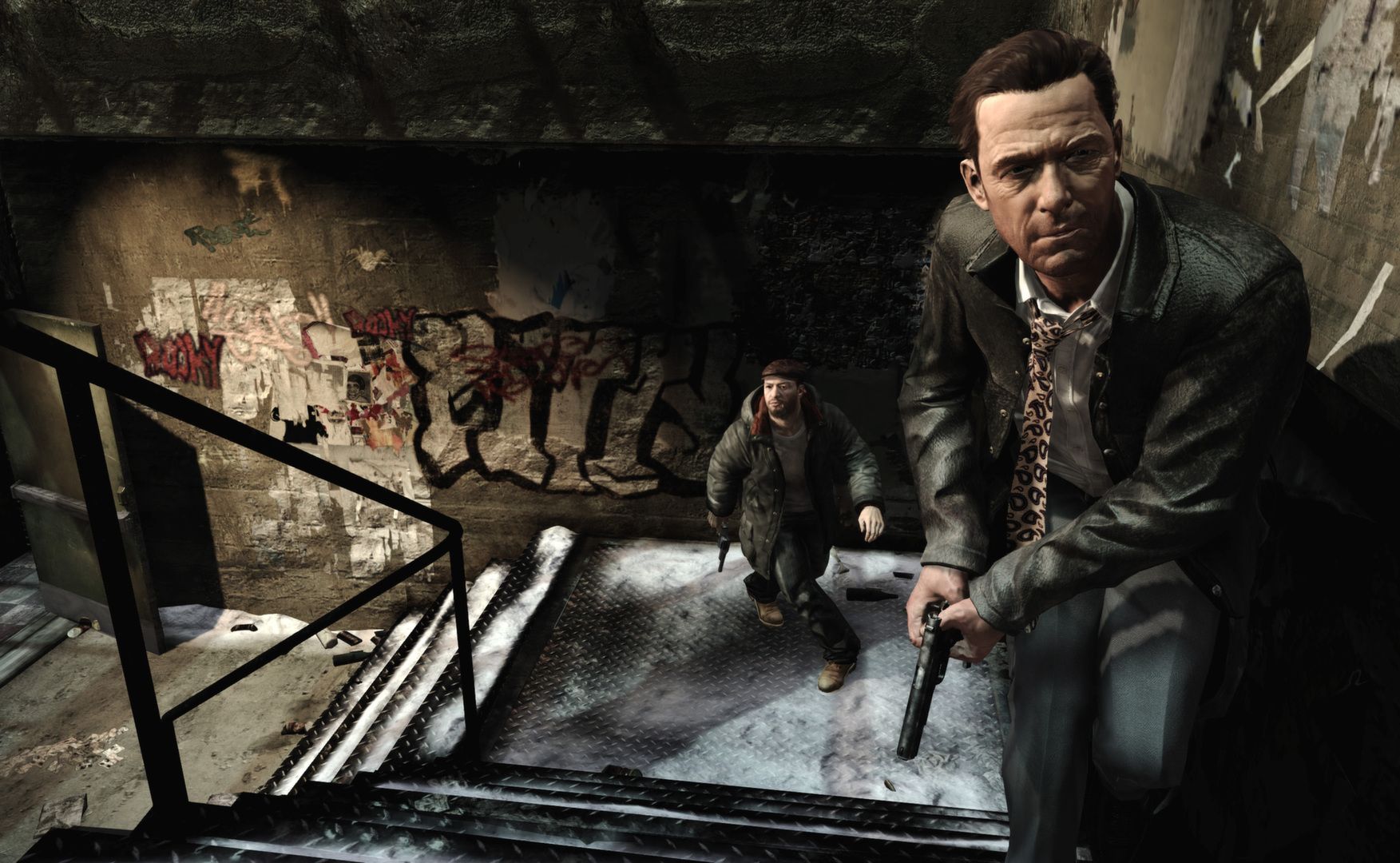 Max climbs a narrow stairway with a pistol while a man with a gun follows below.