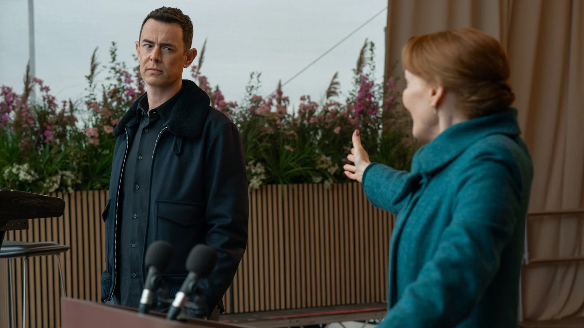 Colin Hanks and Laura Innes sit together in an official Silo Season 3 still.