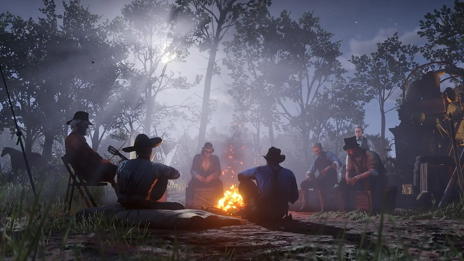 Members of the Van der Linde gang gathered around a campfire at night.