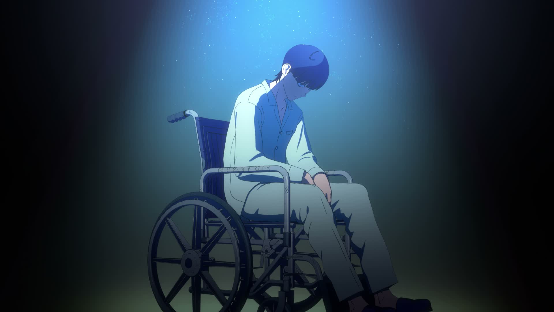 Nagi Taira sits under a blue spotlight in his wheelchair in the Tank Chair anime.