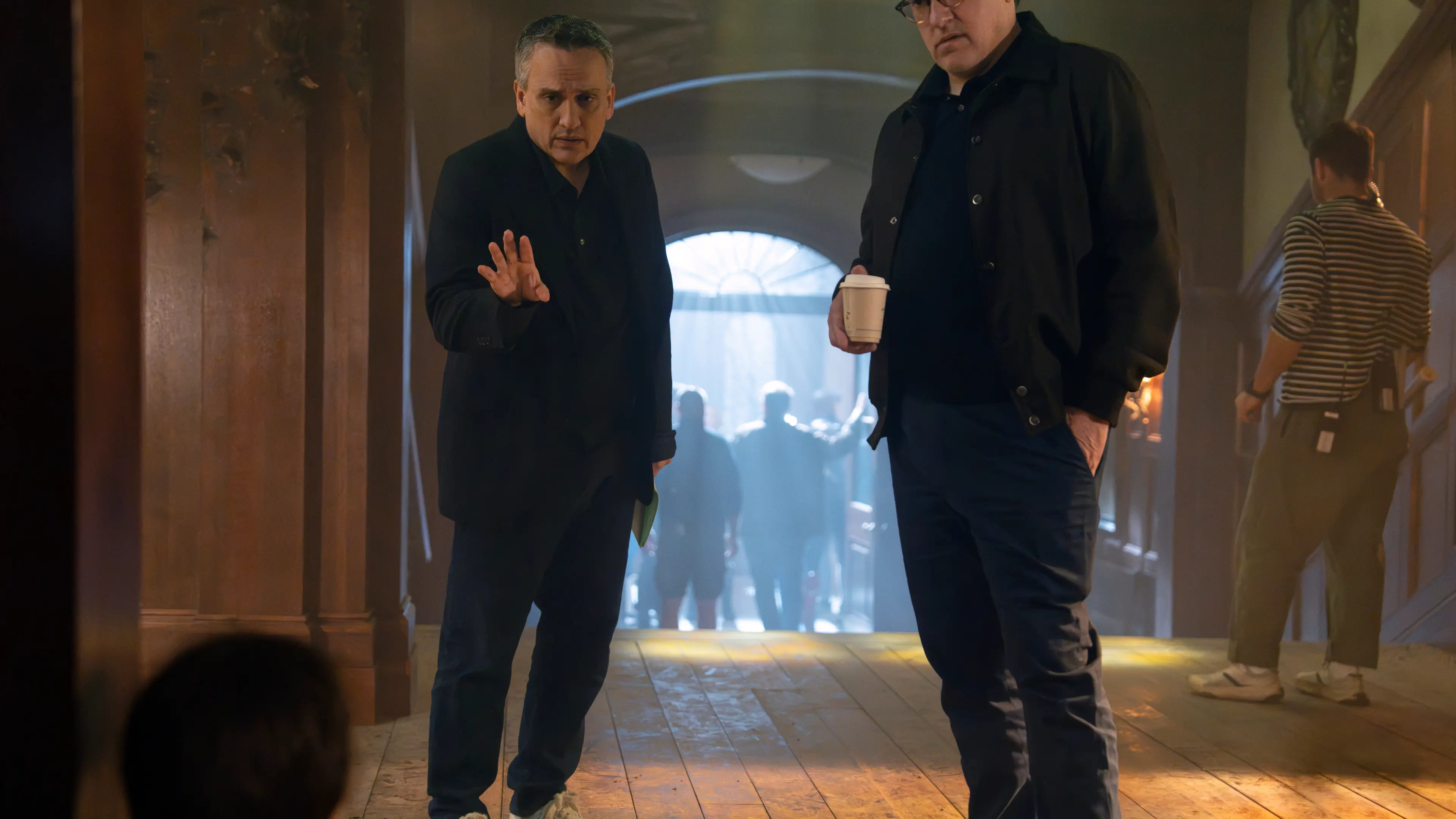 Joe Russo and Anthony Russo stand on the set of Avengers: Doomsday in an official Marvel image.