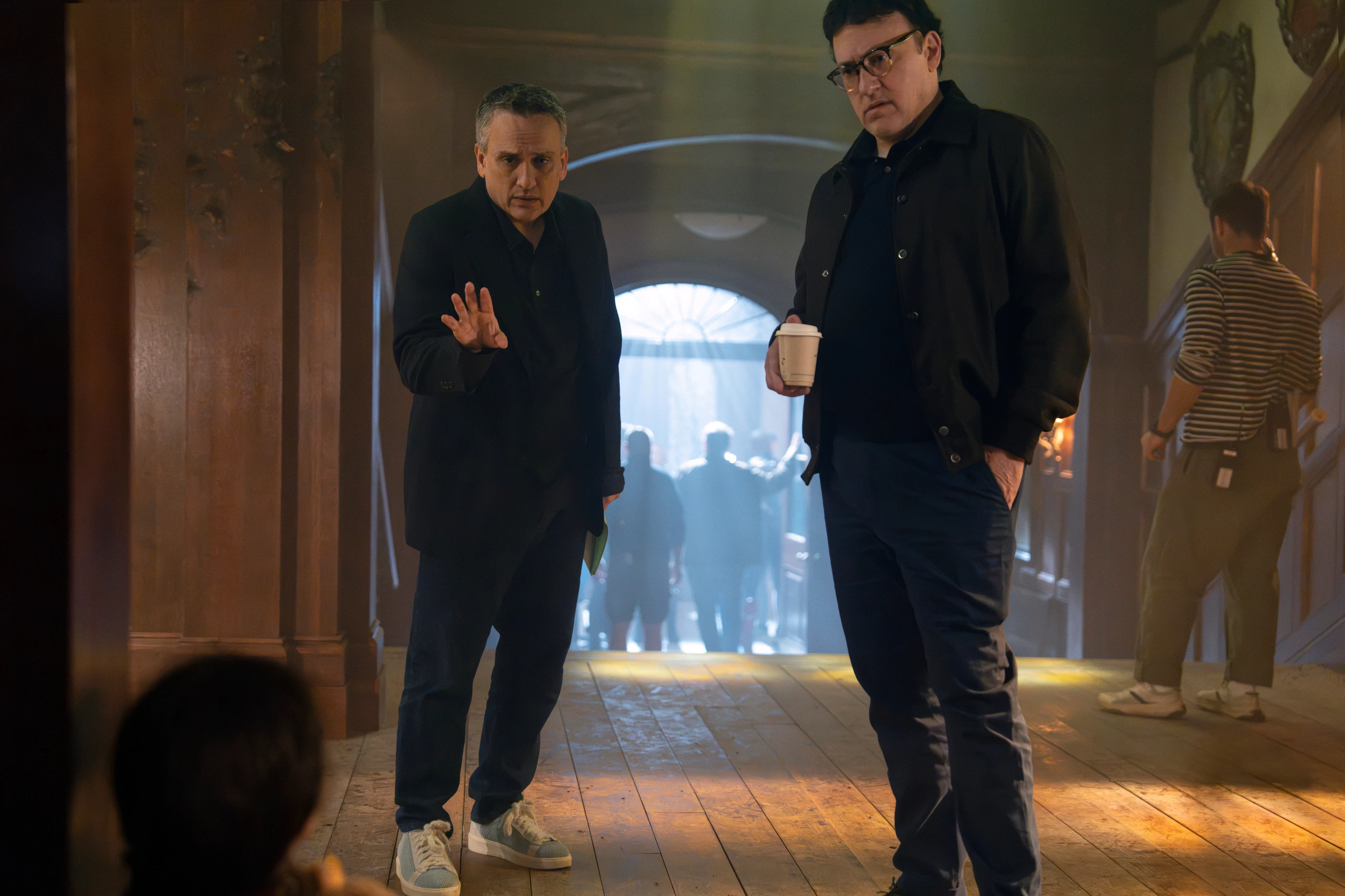 Joe Russo and Anthony Russo stand on the set of Avengers: Doomsday in an official Marvel image.