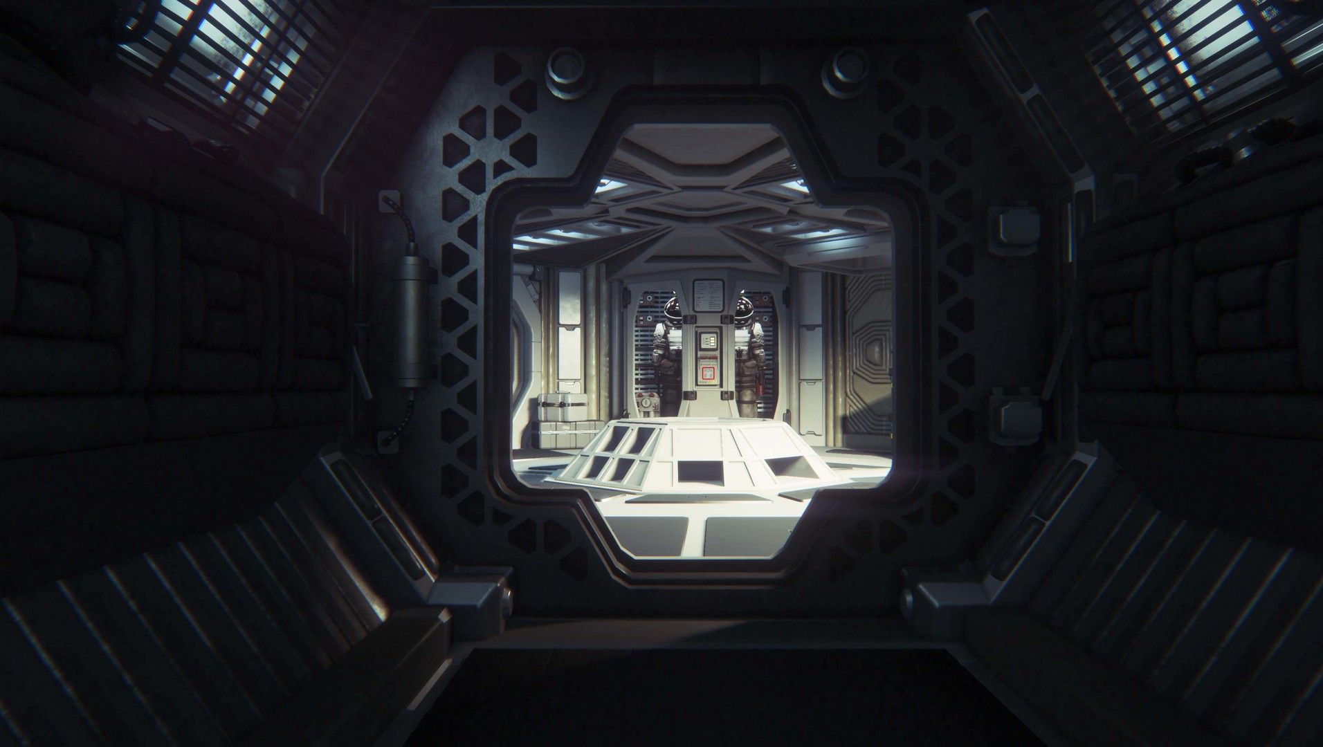 A bright route leads down a dark industrial corridor to a door.