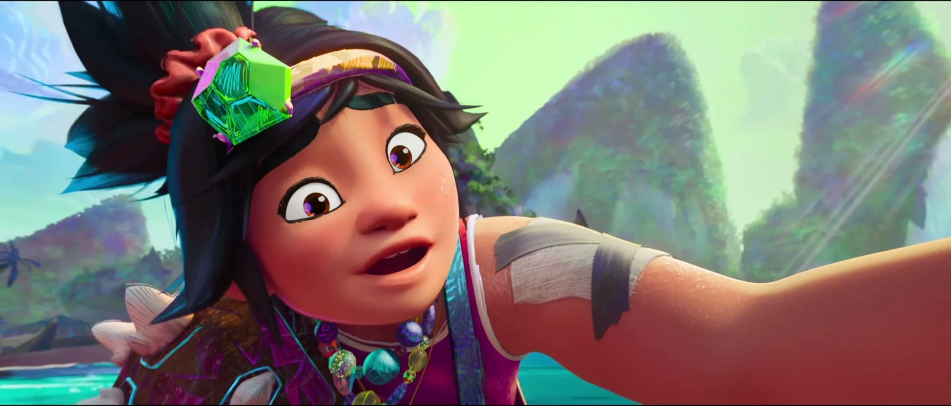 Raissa smiles while holding a phone in Forgotten Island.