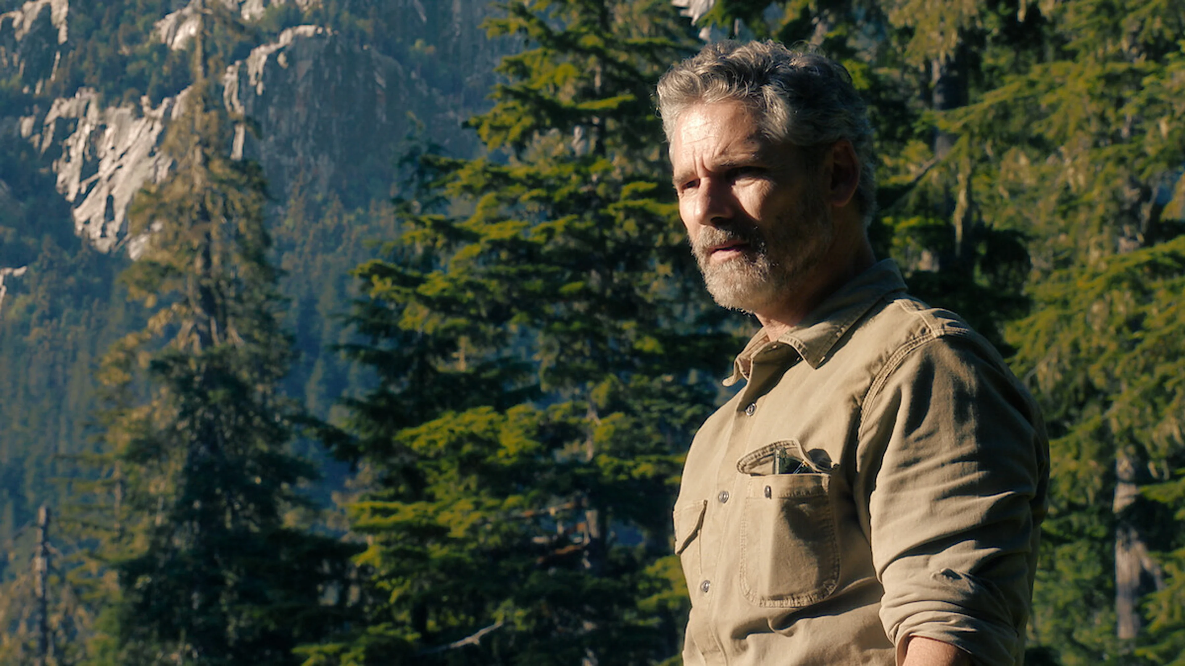 Eric Bana as Kyle Turner stands in a forest in an official UNTAMED still.