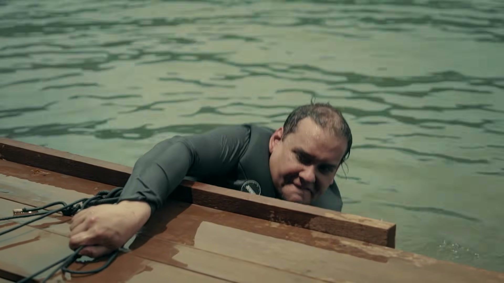 George Santos holds the edge of a wooden raft while in the water in a Special Forces preview.