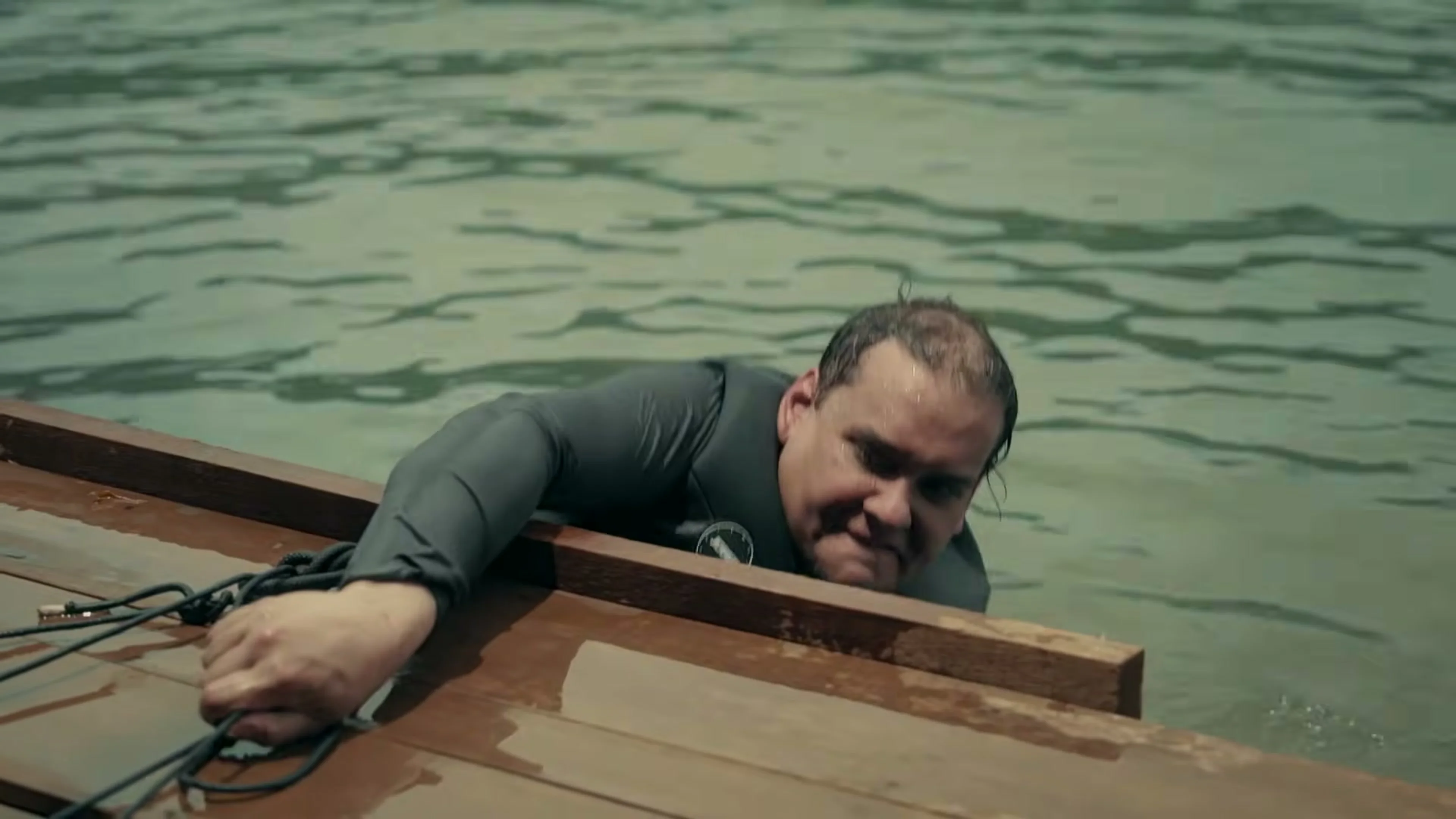 George Santos holds the edge of a wooden raft while in the water in a Special Forces preview.